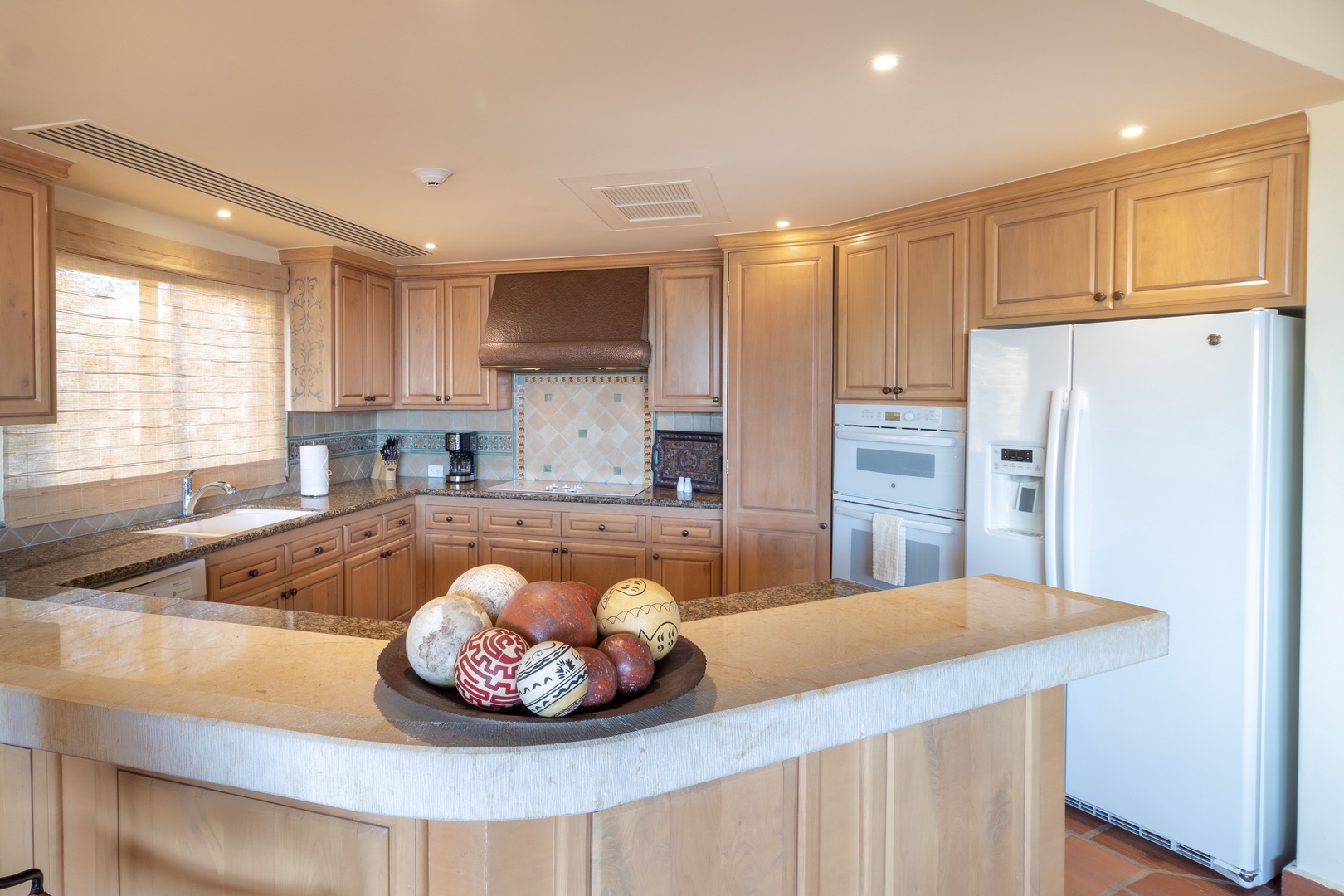 Your fully equipped kitchen features granite countertops, modern appliances, and ample cabinet space—perfect for preparing meals in comfort during your stay.