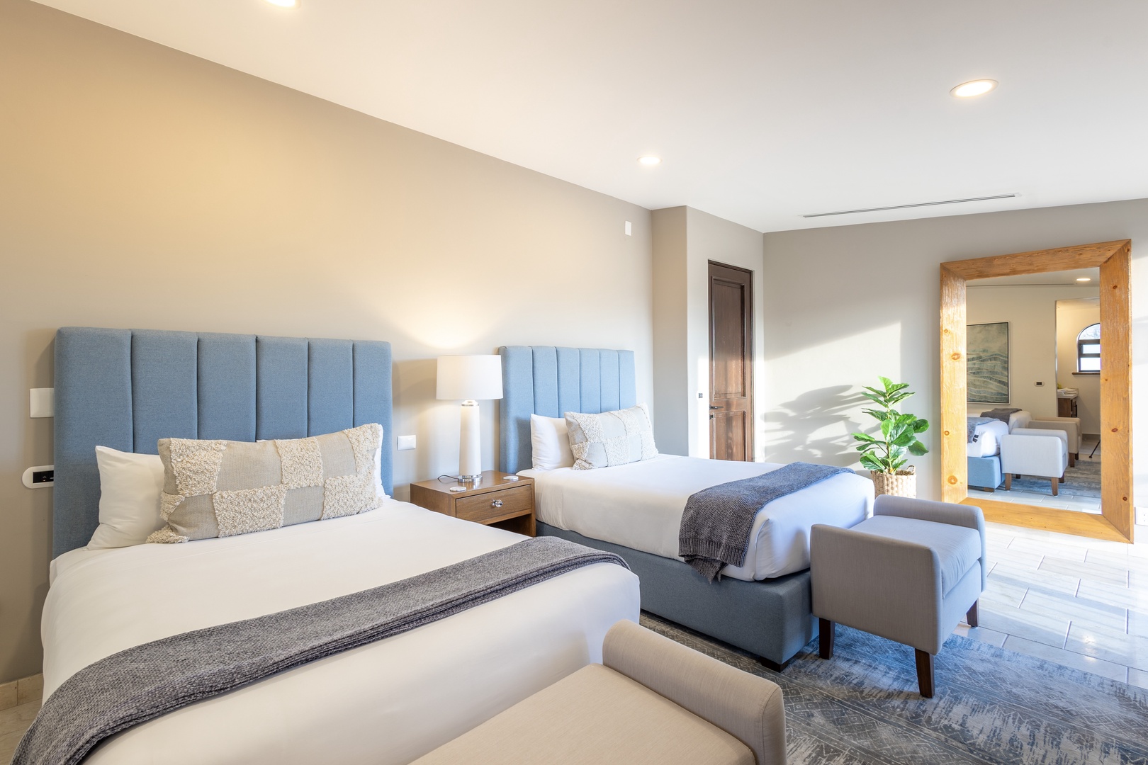 Sink into plush linens and enjoy your own peaceful retreat—two cozy beds await, with soft upholstered headboards and stylish accents inviting you to unwind.