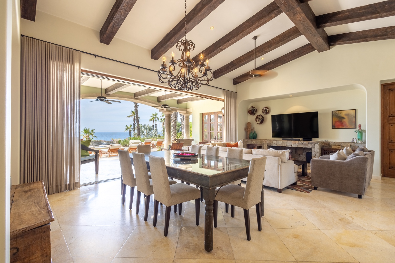 Gather around your elegant dining table under rustic beams while ocean breezes flow through open doors to your private terrace.