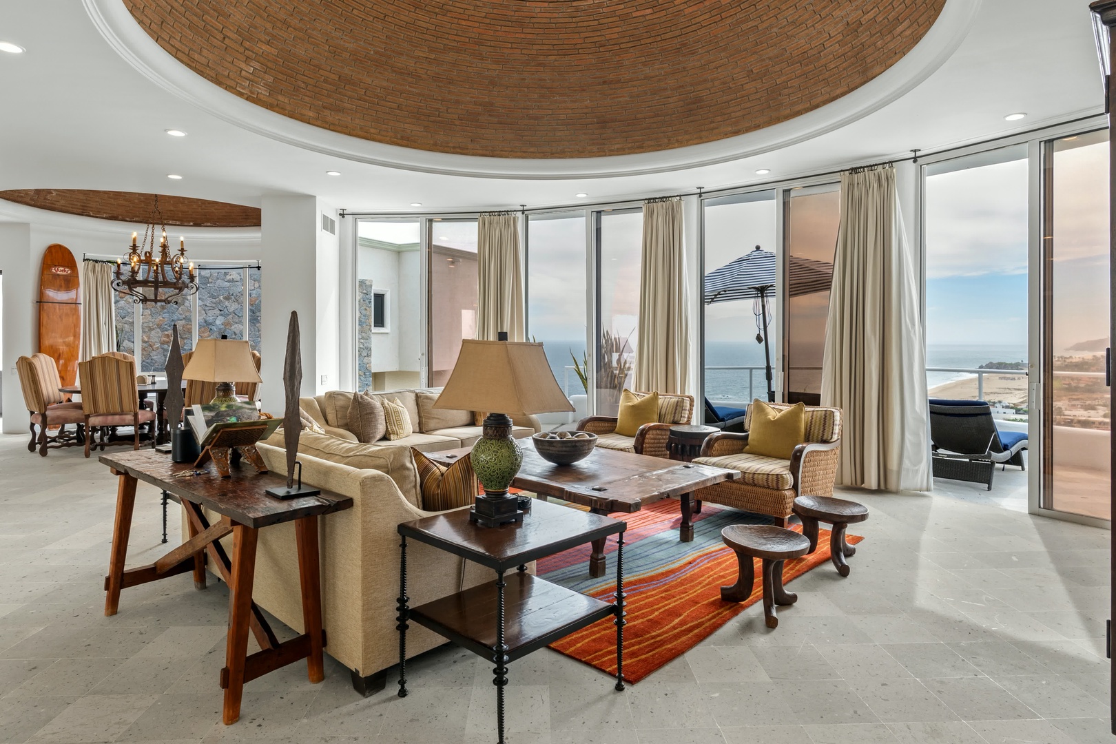 Unwind in your stunning living space featuring soaring brick ceilings, floor-to-ceiling windows, and curated furnishings that create the perfect blend of elegance and comfort.