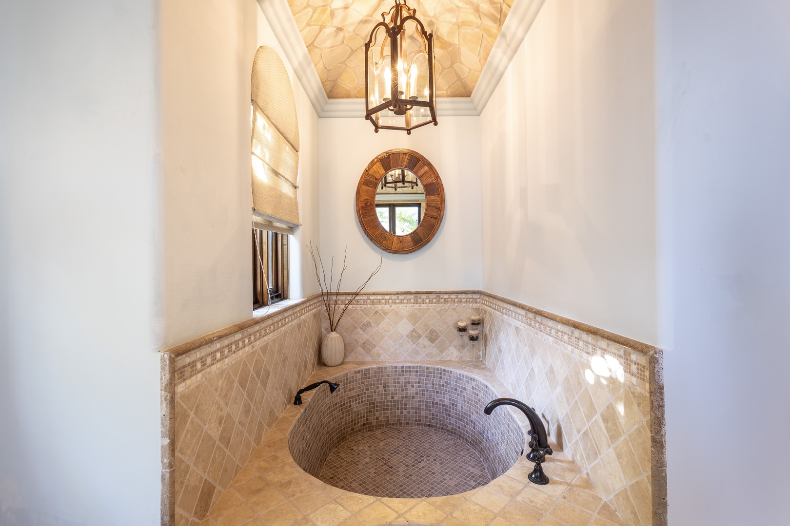 Imagine sinking into your own sunken mosaic tub beneath a stunning tiled ceiling and elegant lantern lighting—a spa-like sanctuary designed just for you.