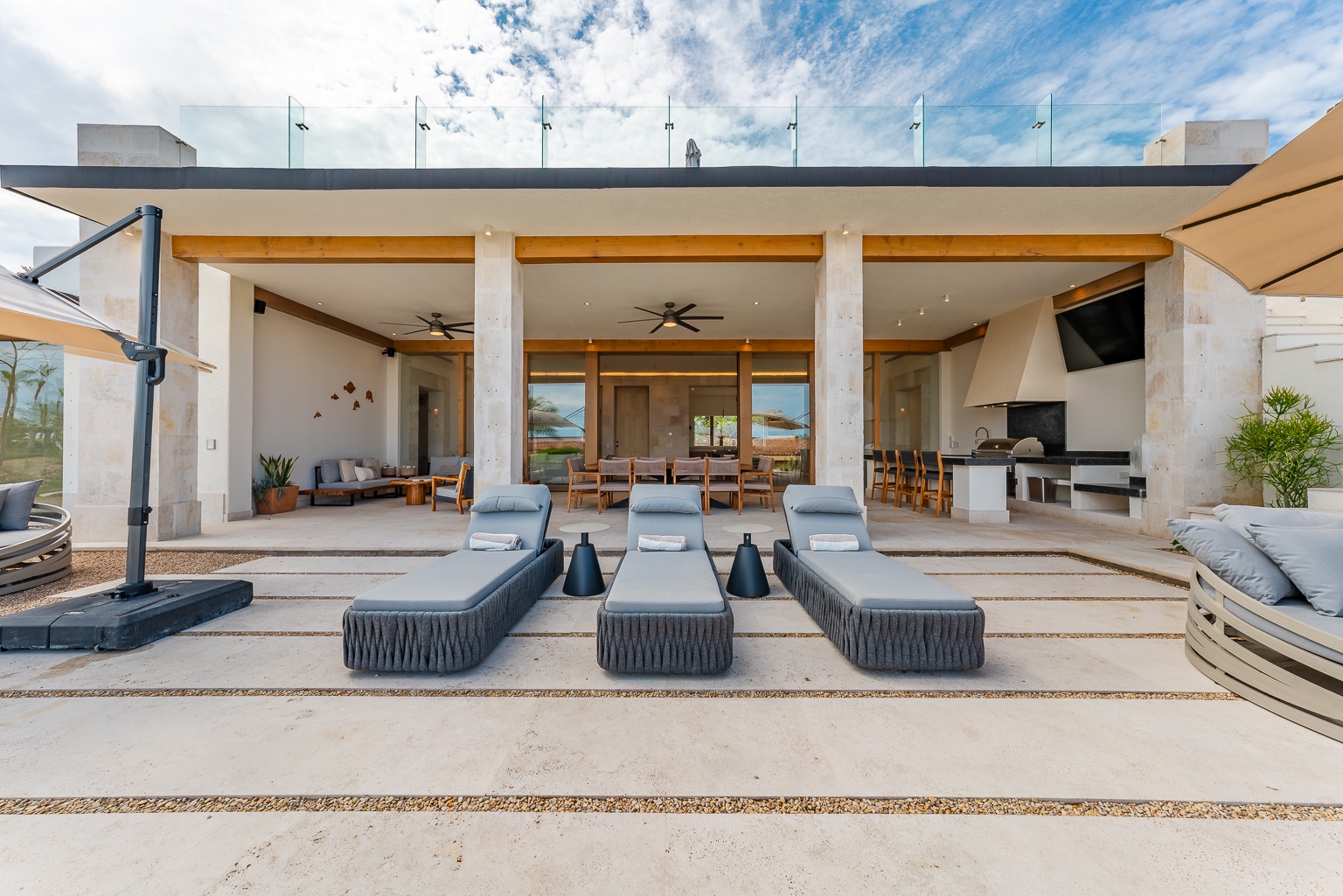 Lounge on your private terrace under open skies, where modern comfort meets coastal elegance. This seamless indoor-outdoor space invites you to relax, dine, and soak in effortless luxury.