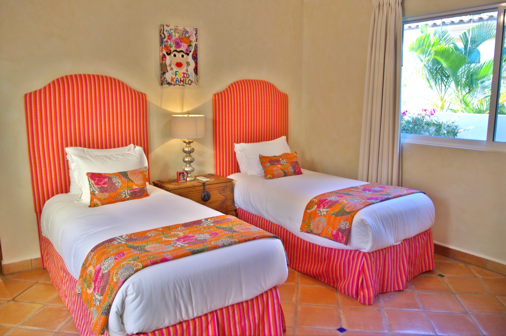 Step into your vibrant twin bedroom with cheerful striped accents and tropical views. Fresh linens and colorful textiles invite you to rest after a day of adventure.