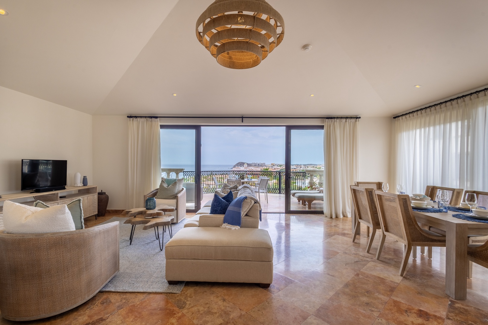 Relax in your elegant living space with stunning views through floor-to-ceiling windows, where warm textures and thoughtful design create the perfect retreat.