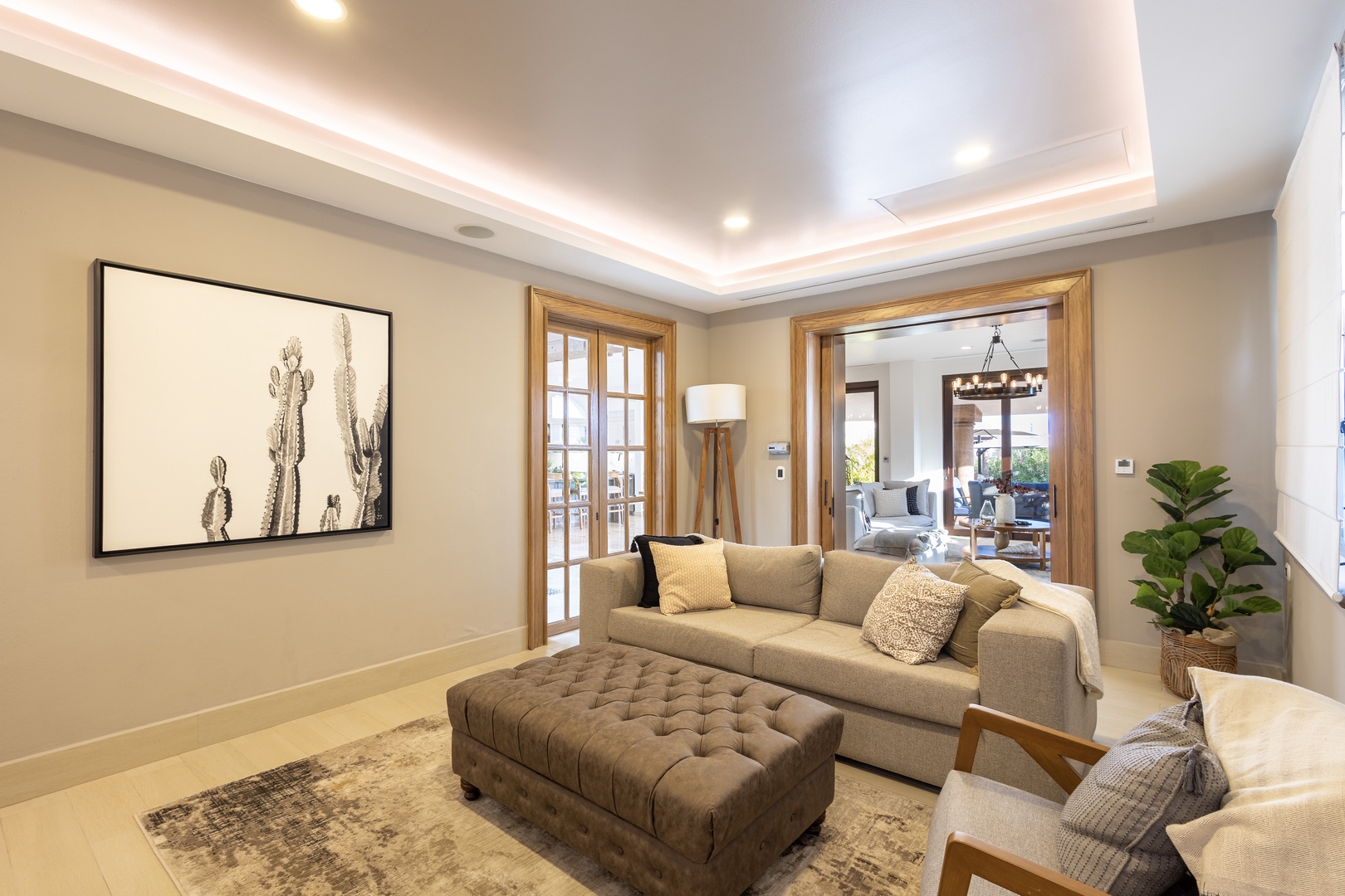Step into your elegant living space, where soft lighting and plush furnishings create a warm, inviting atmosphere perfect for relaxing after exploring the area.