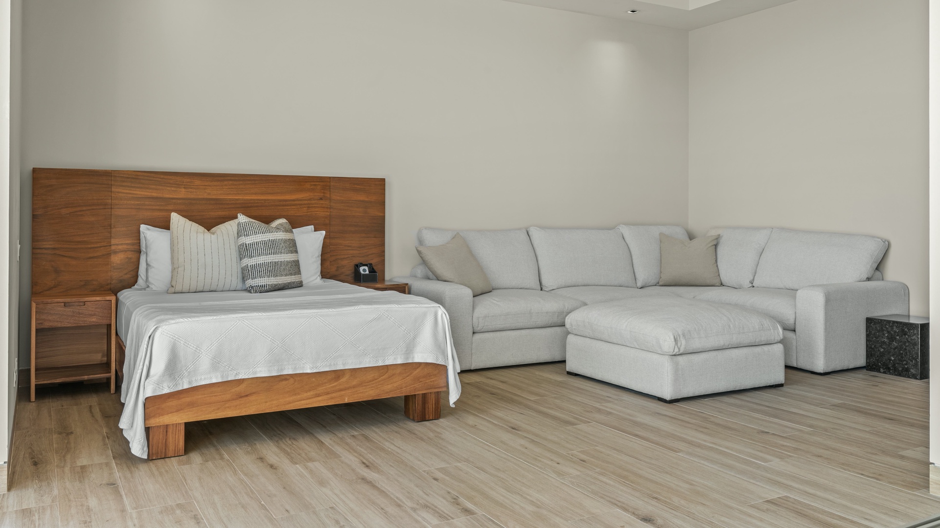 Your bright, open studio features a cozy bed with designer pillows and a spacious sectional sofa—perfect for unwinding after your adventures or hosting friends.