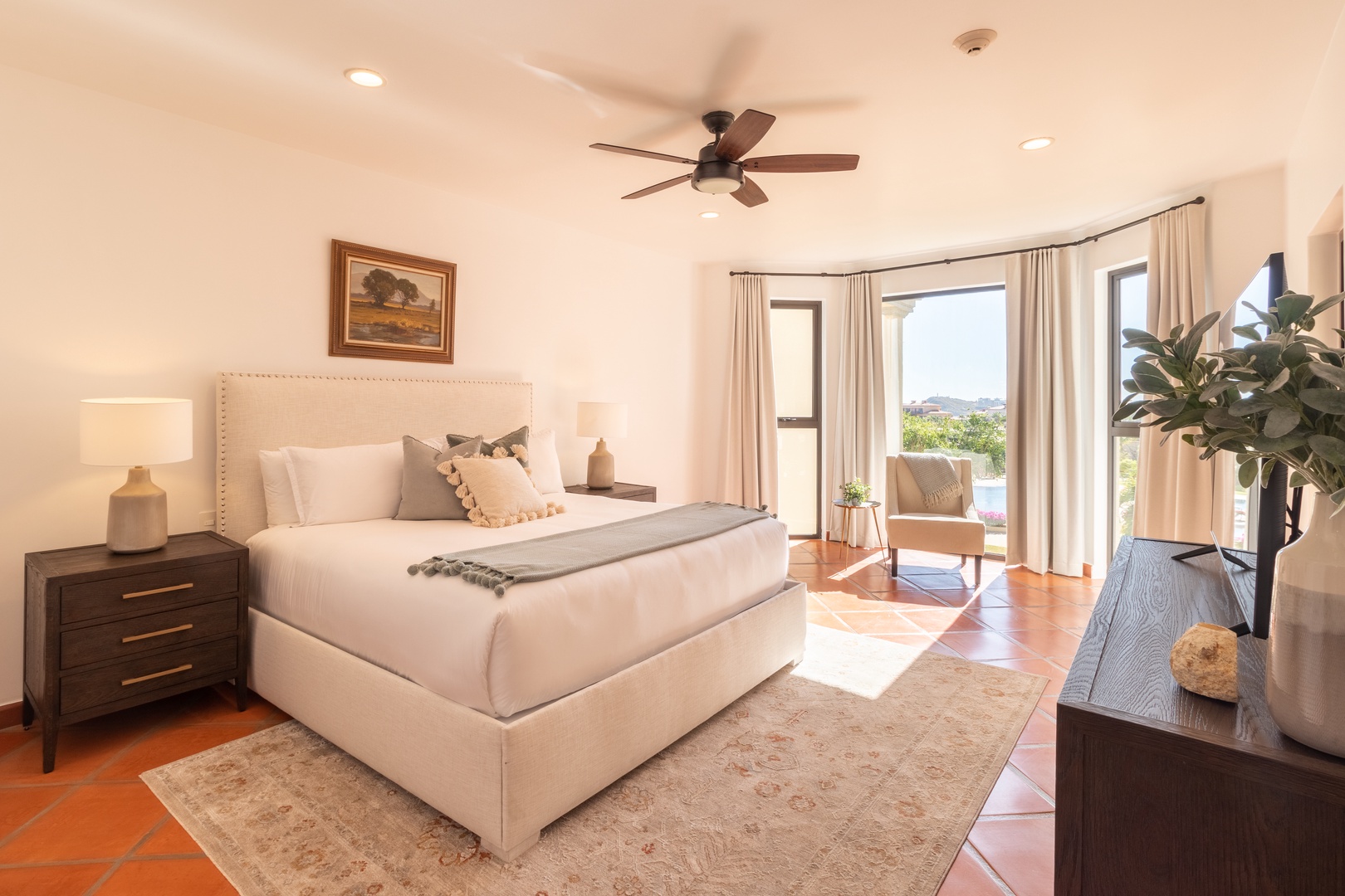Sink into crisp linens and wake to serene views through your private patio doors. Warm terracotta tiles and soft coastal breezes create your perfect escape.