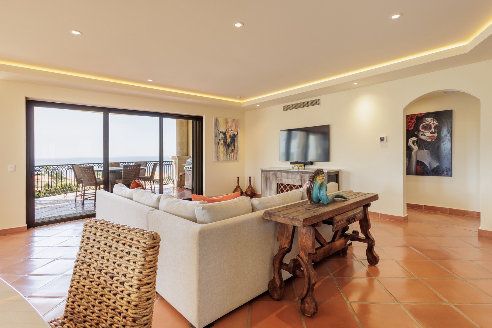 Relax in your spacious living room with comfortable seating, a mounted TV, and a stunning balcony view. Natural light fills the space, making it perfect for unwinding after a day of exploration.