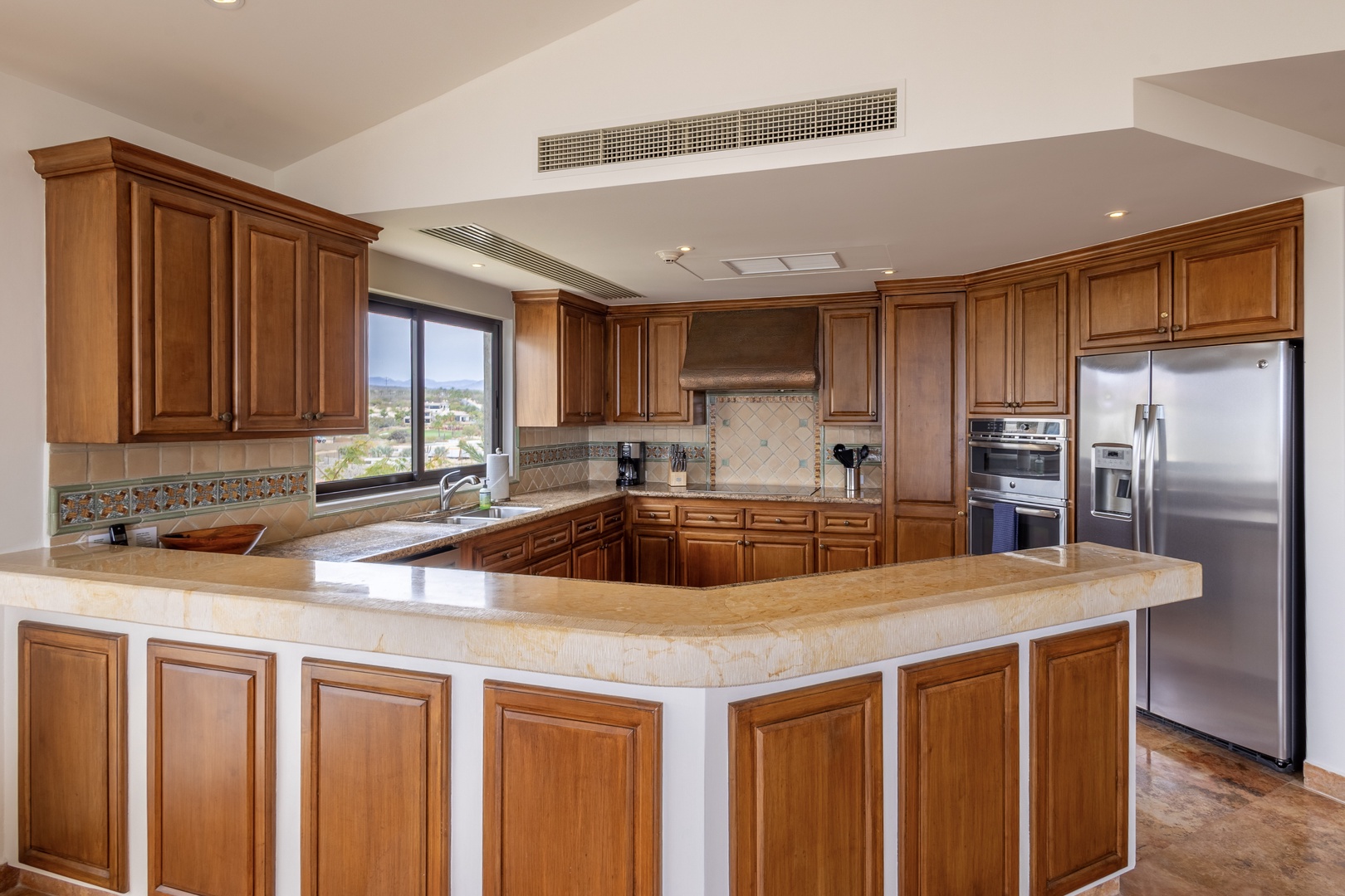 Your fully-equipped gourmet kitchen awaits with granite counters, rich cabinetry, and stainless steel appliances perfect for creating memorable meals.