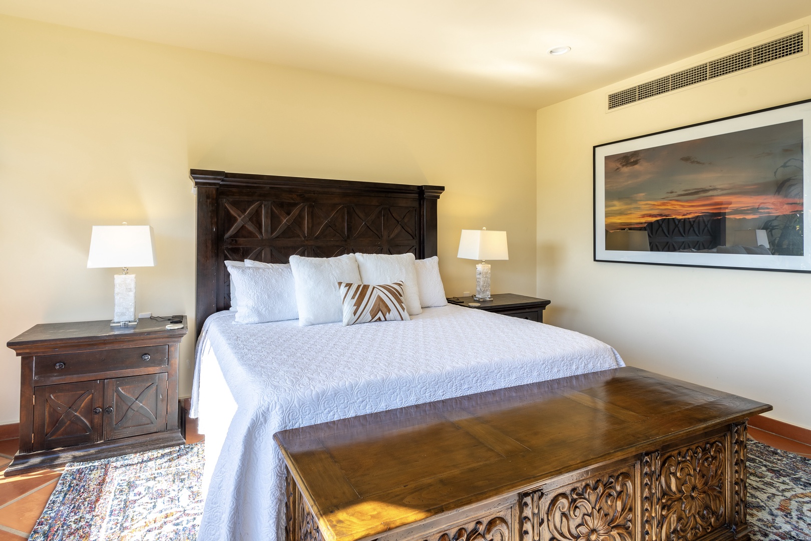 Sink into crisp linens and handcrafted wooden elegance in your serene bedroom retreat, where comfort meets authentic charm.