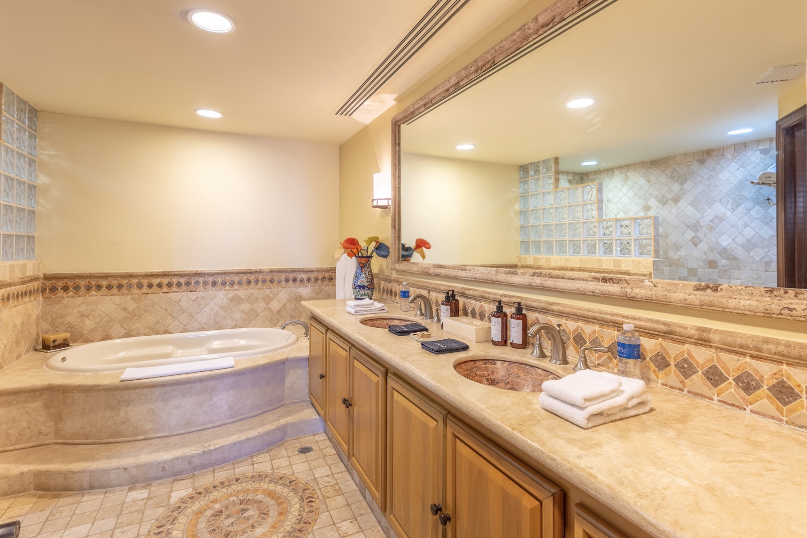 You'll love the spacious bathroom with its luxurious soaking tub, dual vanity sinks, and elegant tile work—perfect for unwinding after a day of adventure.