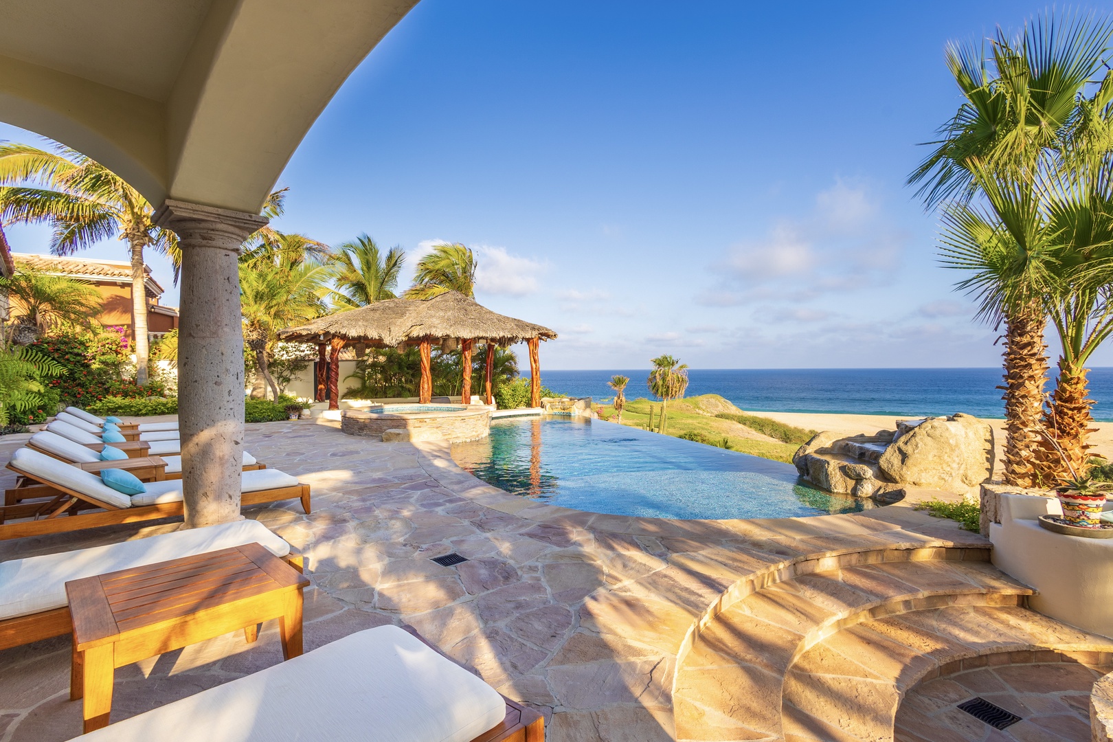 Sink into plush poolside loungers as gentle ocean breezes and swaying palms surround you. Your private infinity pool shimmers under the sun, framing endless sea views and moments of pure relaxation.