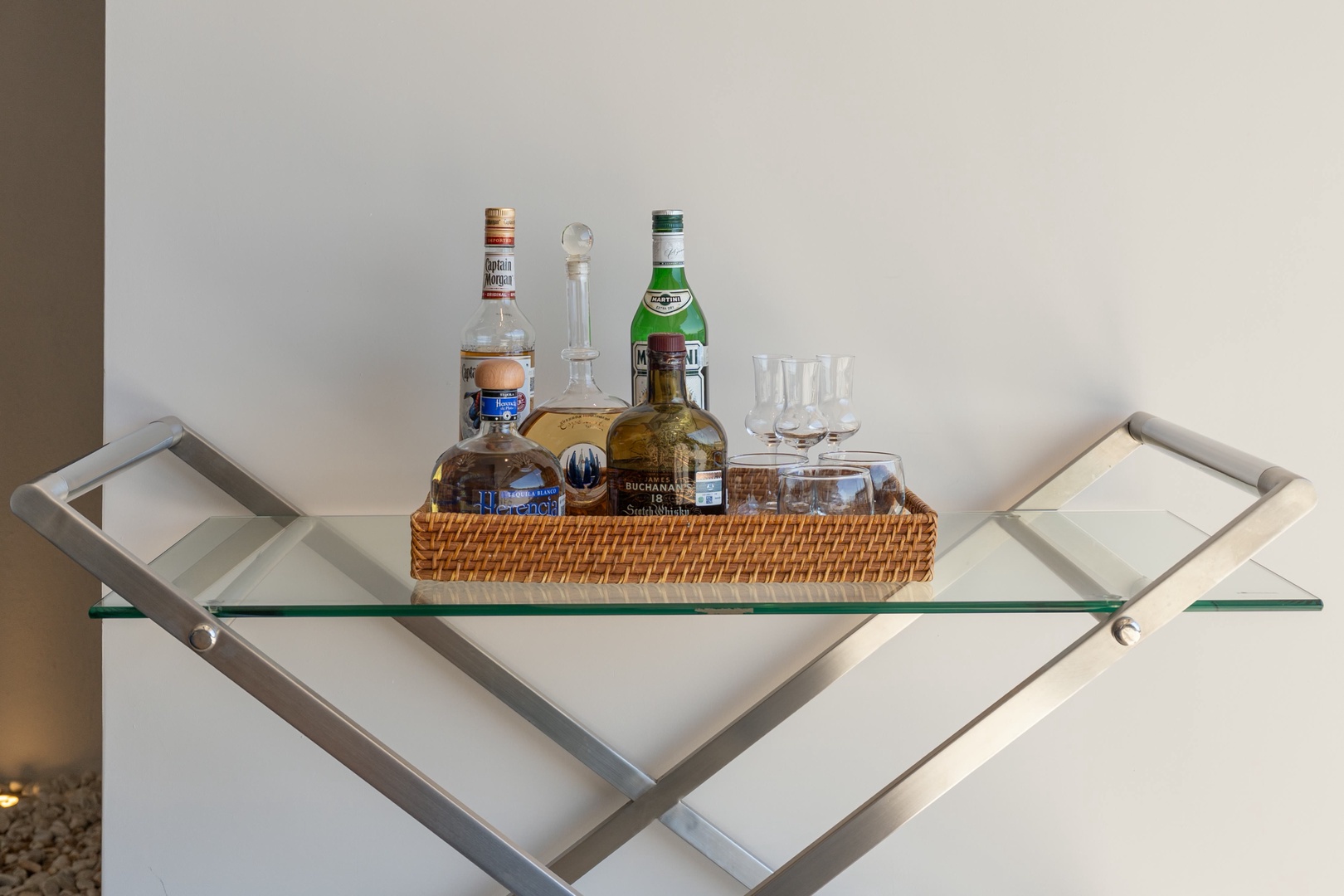 Pour yourself a cocktail from the curated bar cart, complete with premium spirits and glassware ready for your evening unwind.