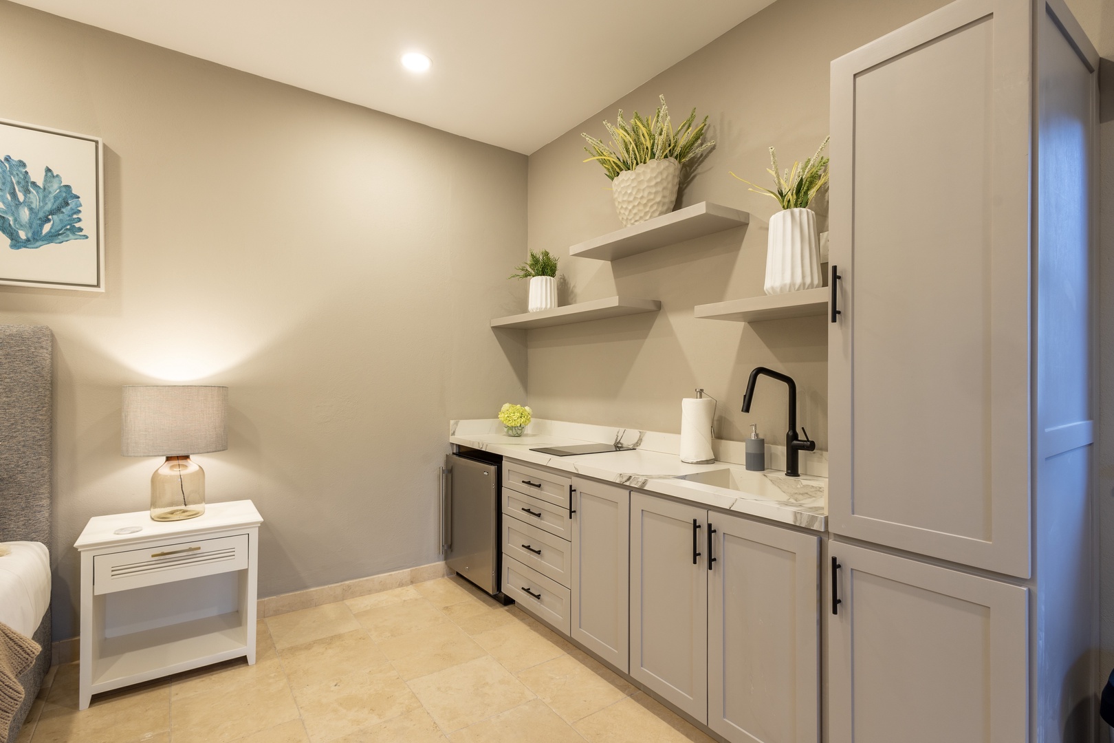 Your private kitchenette offers stylish convenience with marble countertops, a mini fridge, and elegant open shelving—perfect for preparing light meals or storing your favorite snacks in relaxed comfort.