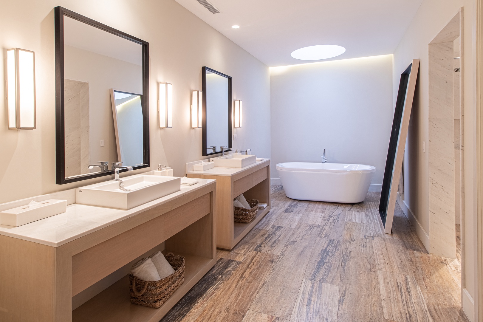 Your private spa sanctuary awaits with a luxurious soaking tub, dual vanities, and warm ambient lighting perfect for unwinding after a day of adventure.