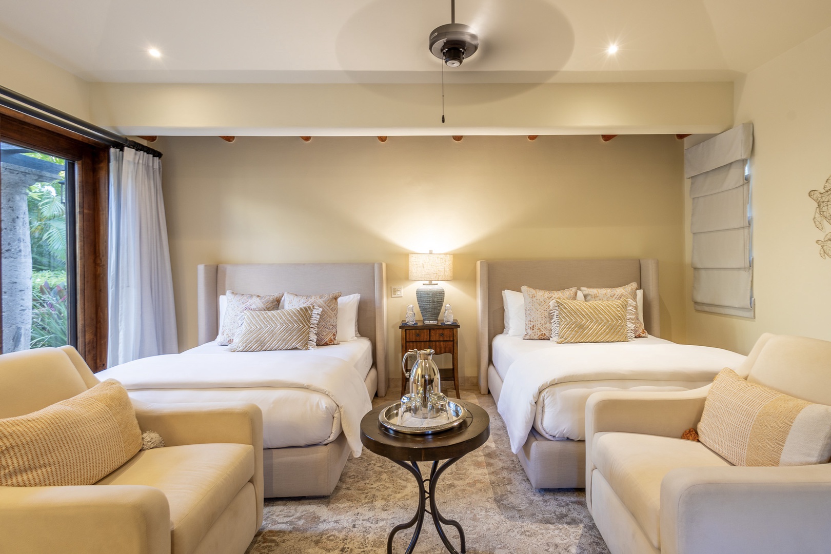 Sink into plush comfort in your serene retreat, where two beds promise restful nights and stylish lounge seating invites you to unwind with garden views just beyond the window.