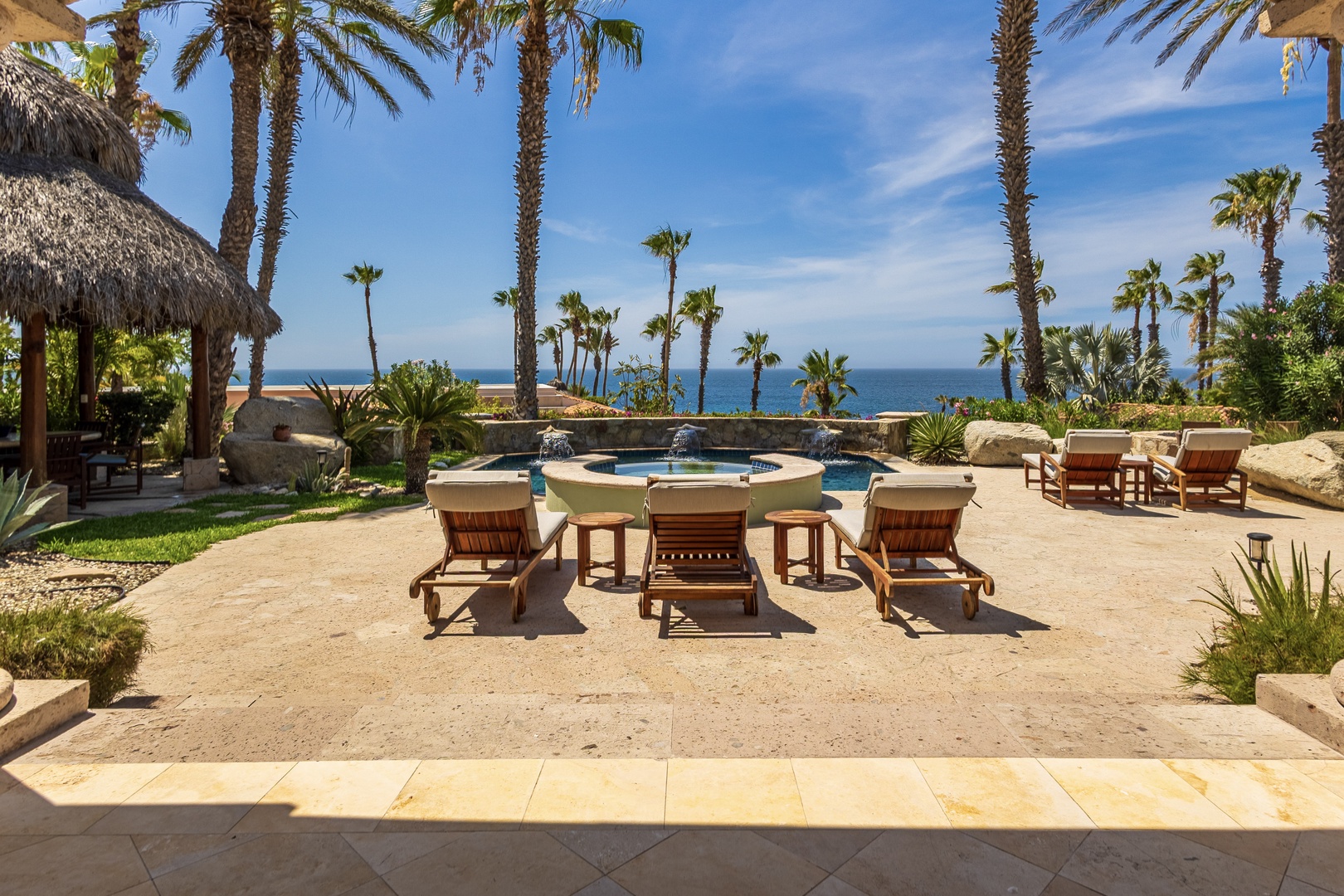 Stretch out on a sun lounger by your private pool and soak in breathtaking sea views framed by swaying palms—your perfect tropical escape awaits.