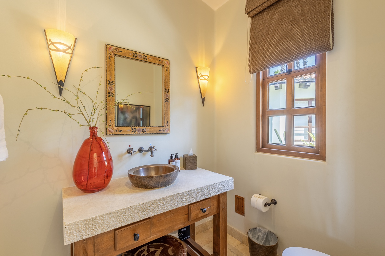 Step into your elegantly appointed powder room, where warm lighting and artisan fixtures create a welcoming atmosphere for your daily routines.