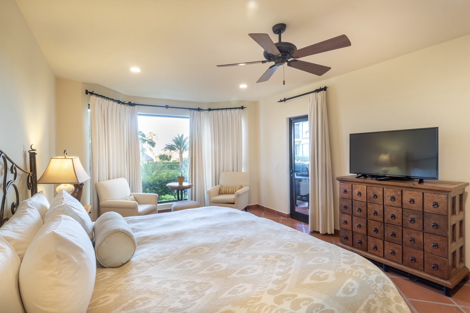 Sink into plush bedding and wake to tropical garden views from your private balcony. Your ceiling fan and bright, airy space invite total relaxation.