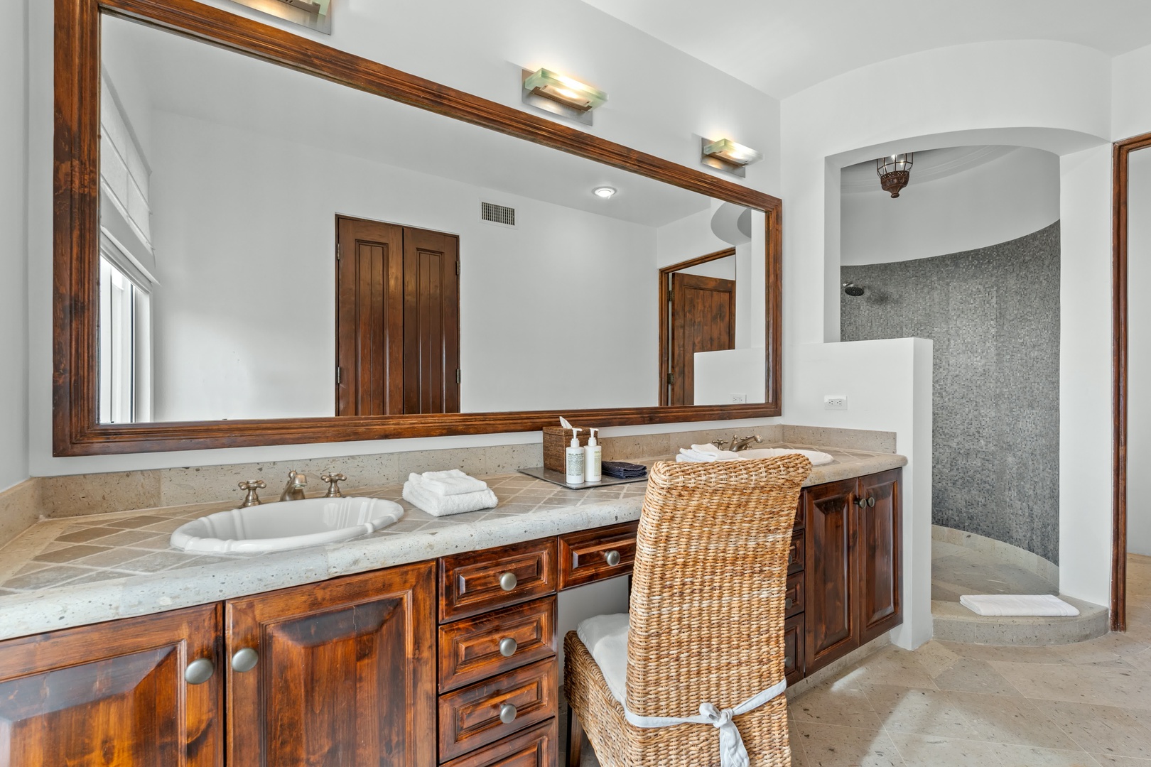 Step into your luxurious master bathroom featuring elegant wood vanity, marble countertops, and spa-like shower retreat.