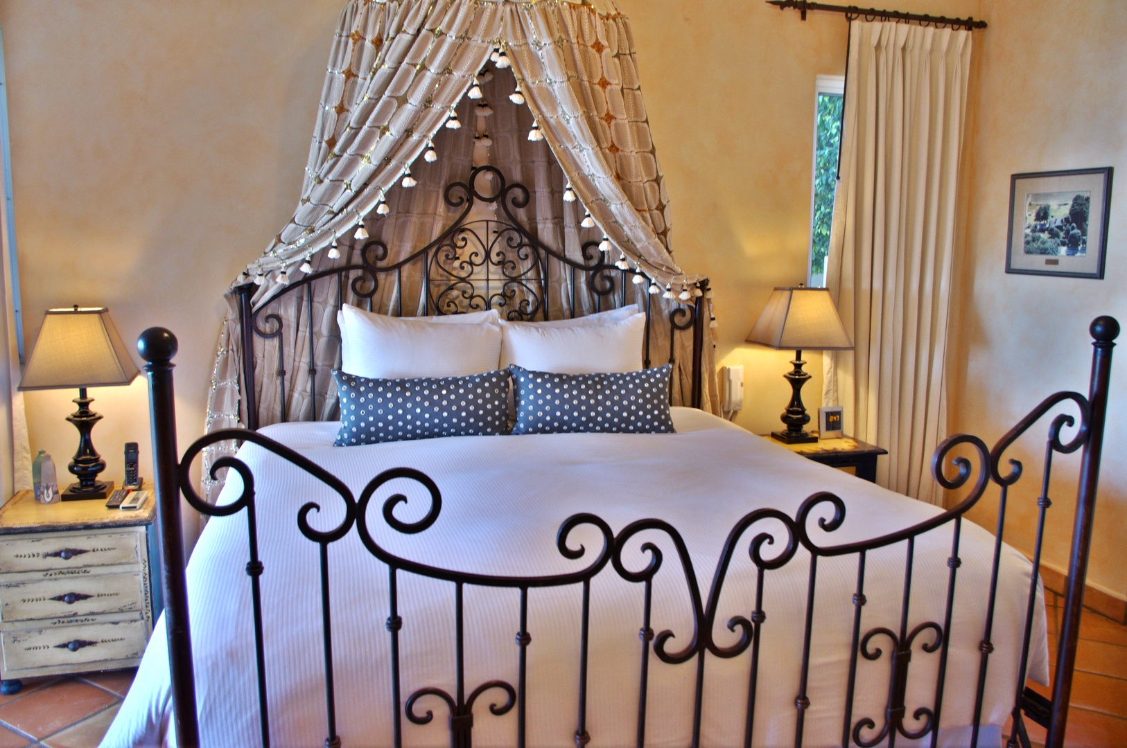 Sink into plush linens beneath romantic drapery and twinkling lights, where your elegantly appointed bedroom awaits to cocoon you in warmth and comfort after every adventure.