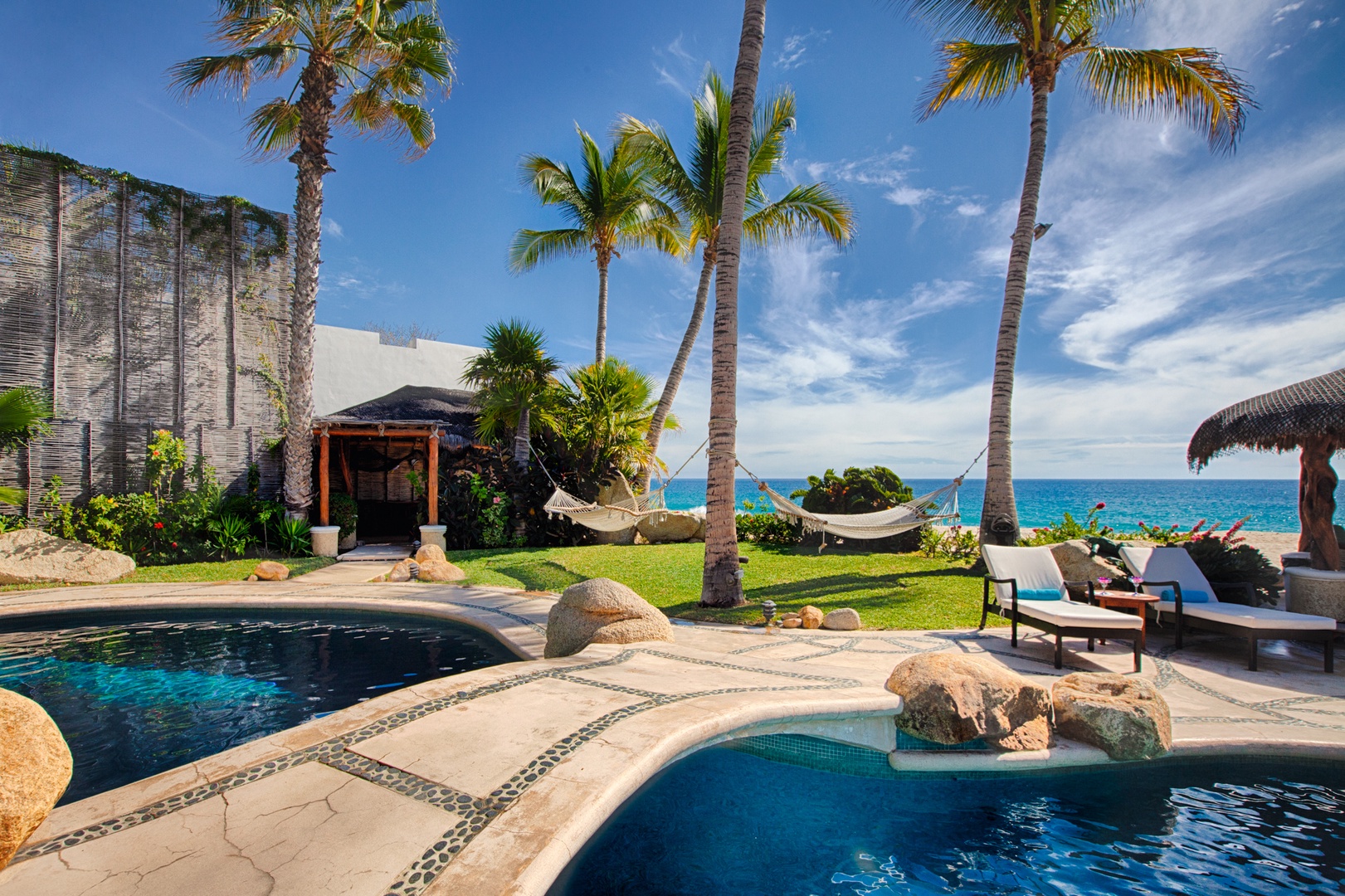 Beachfront paradise with private pool, swaying palms, and direct ocean access for your perfect tropical escape.