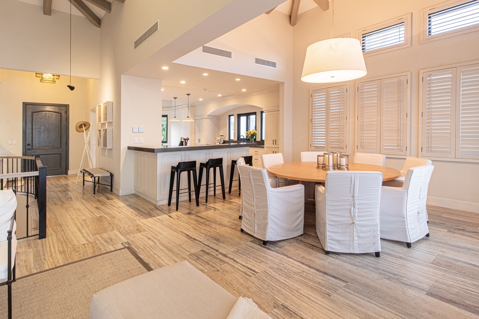 Step into your open-concept retreat with soaring ceilings and gleaming wood floors. The heart of your home flows effortlessly from the spacious kitchen to your elegant dining table, where you'll gather with loved ones and create lasting memories.