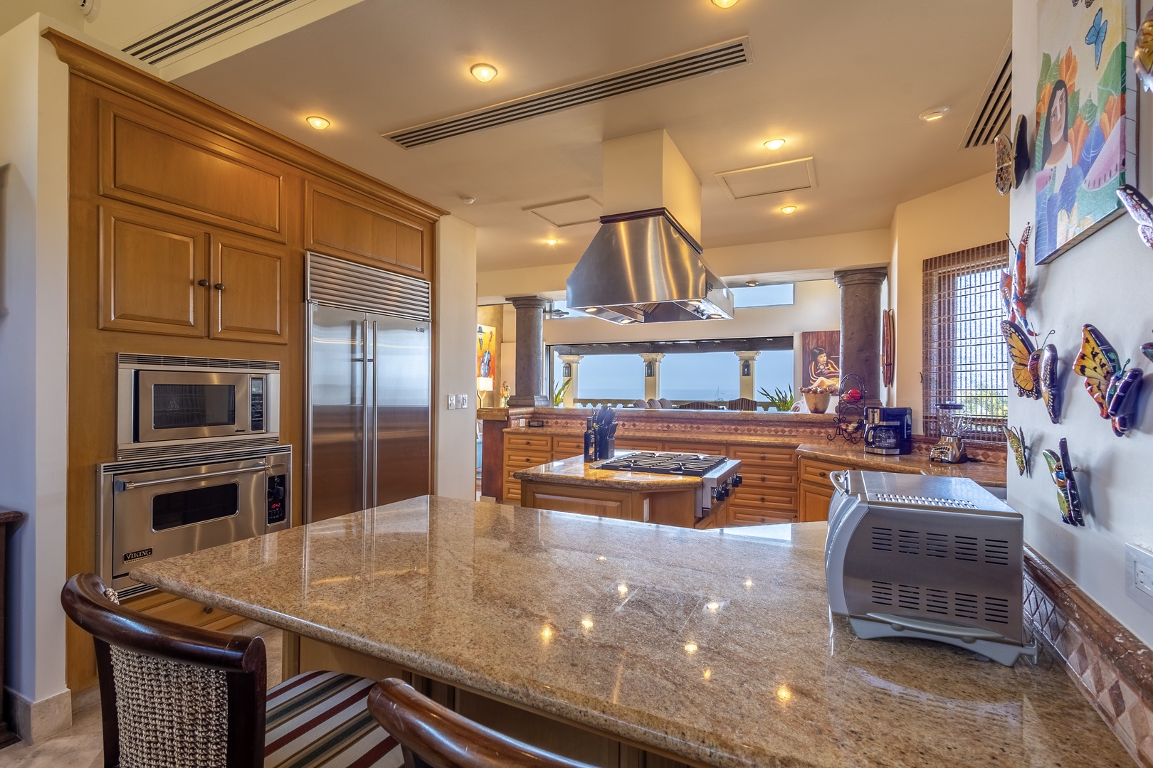 Imagine preparing meals in this spacious gourmet kitchen, with gleaming granite counters, pro-grade appliances, and stunning ocean views framing your culinary experience.