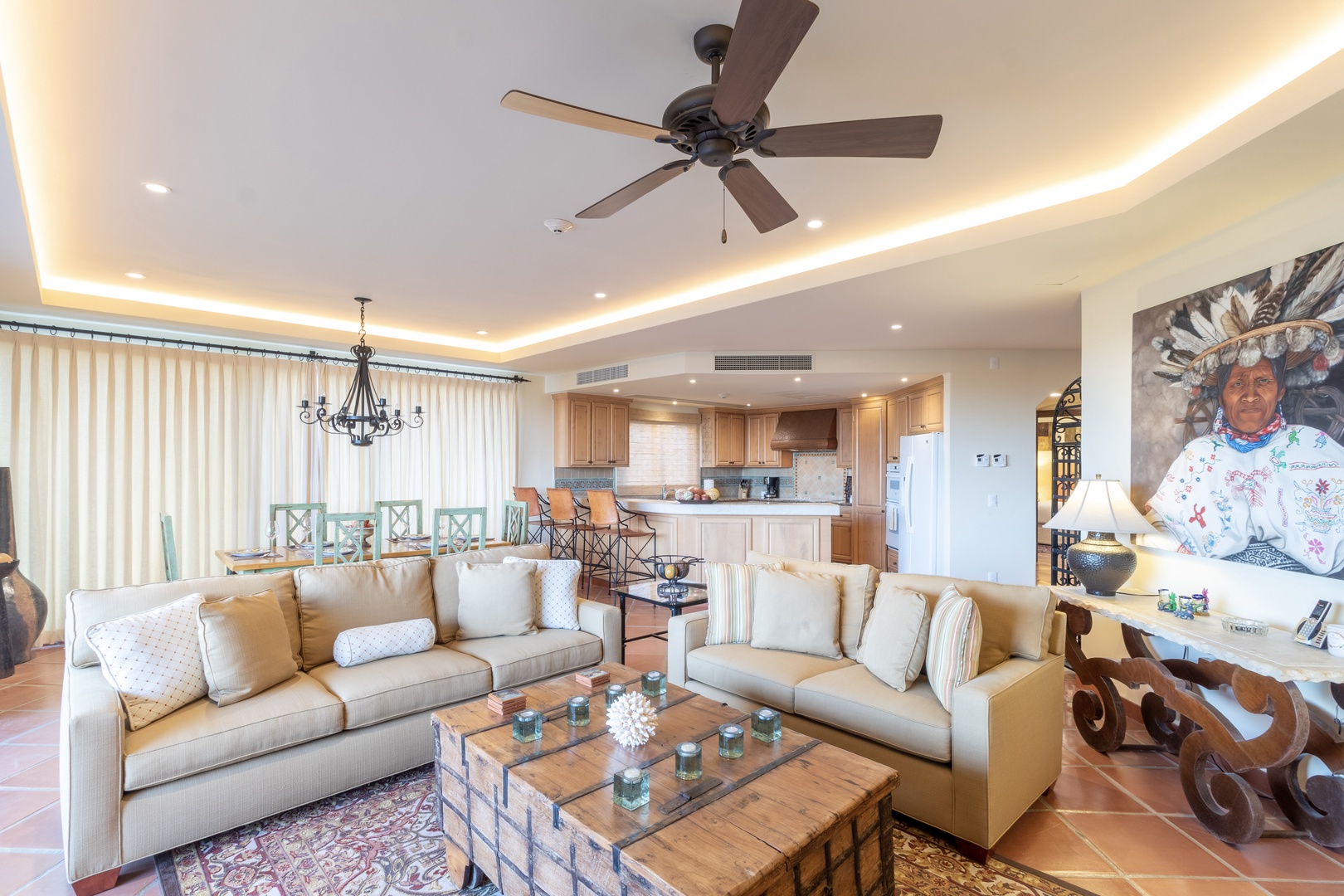 Picture yourself unwinding in this open, sunlit space where plush seating meets a fully equipped kitchen. Warm wood tones and soft ambient lighting create a perfect setting for your home-away-from-home retreat.