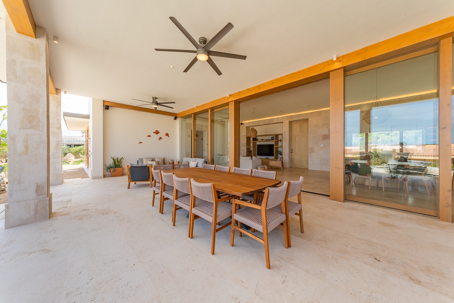 Gather for meals and conversation at this spacious covered terrace, where your indoor and outdoor living spaces blend seamlessly together in effortless comfort.