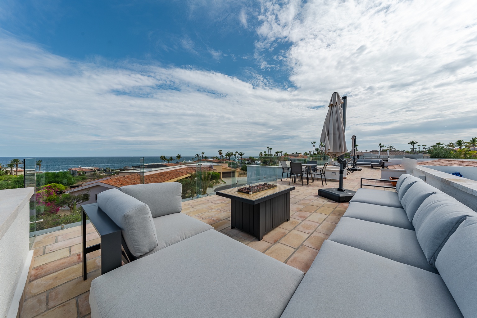 Picture yourself on this expansive rooftop terrace, where plush seating and a cozy fire table await beneath open skies. Ocean breezes and sweeping coastal views create the perfect setting for your morning coffee or sunset cocktails.