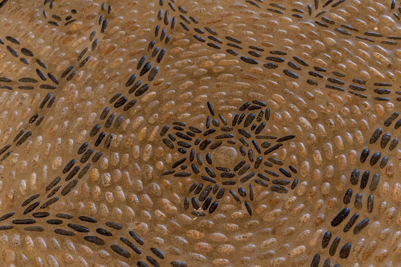 An aerial view reveals intricate circular patterns etched into the desert landscape, showcasing unique natural or man-made formations near the property.