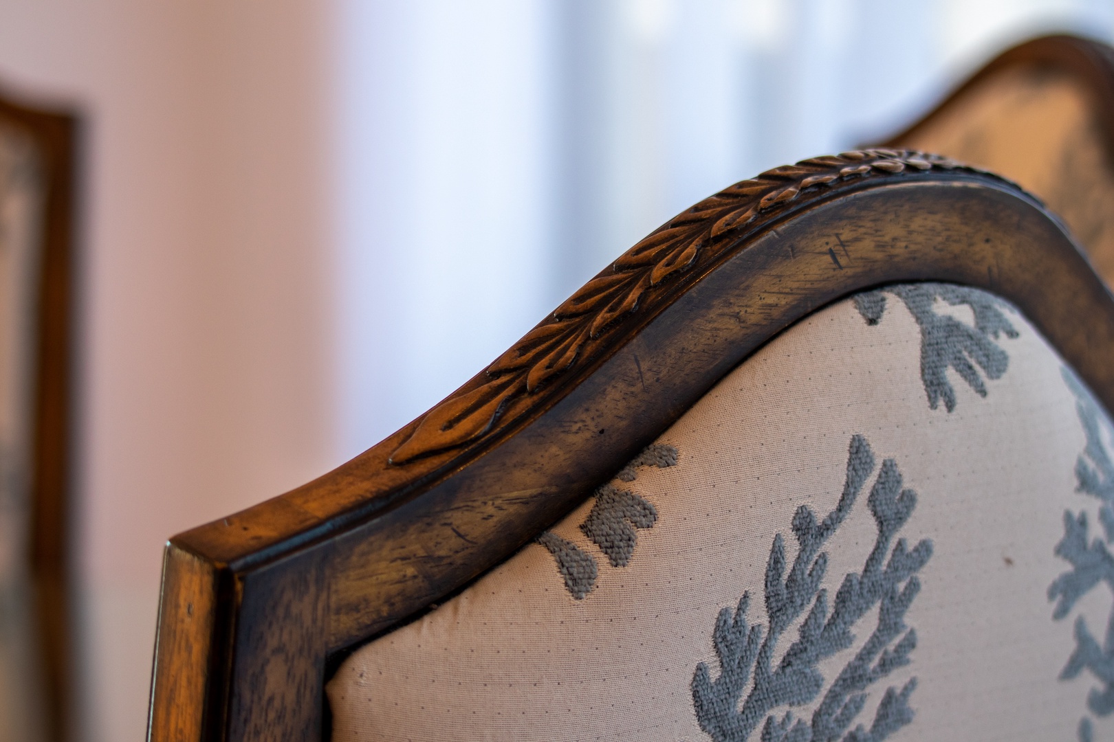 Vintage upholstered chair with carved wood detailing adds timeless character and comfort to your living space.