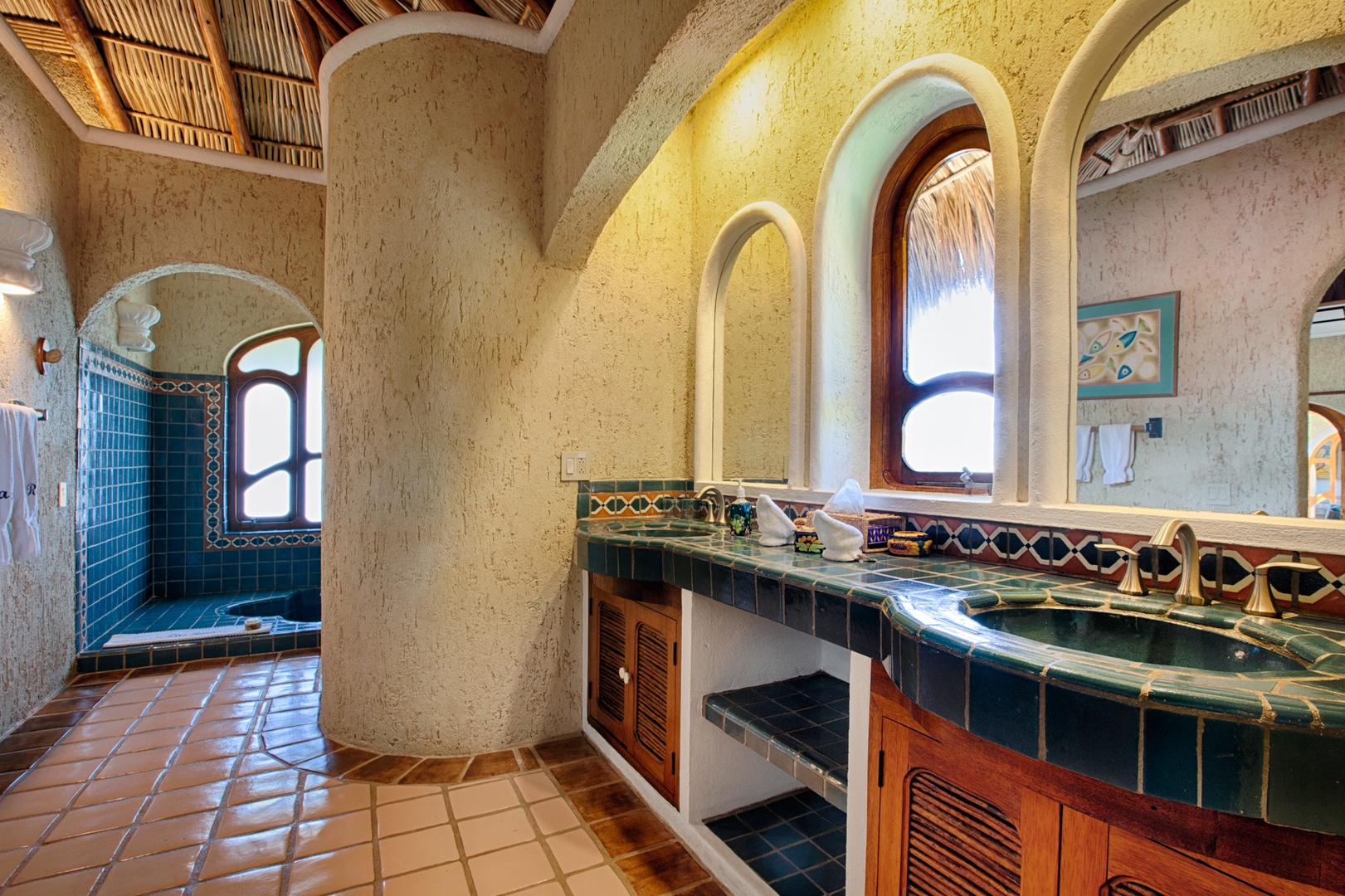 Immerse yourself in authentic Mexican charm with handcrafted Talavera tiles, rustic beams, and artisan details throughout your private bathroom oasis.
