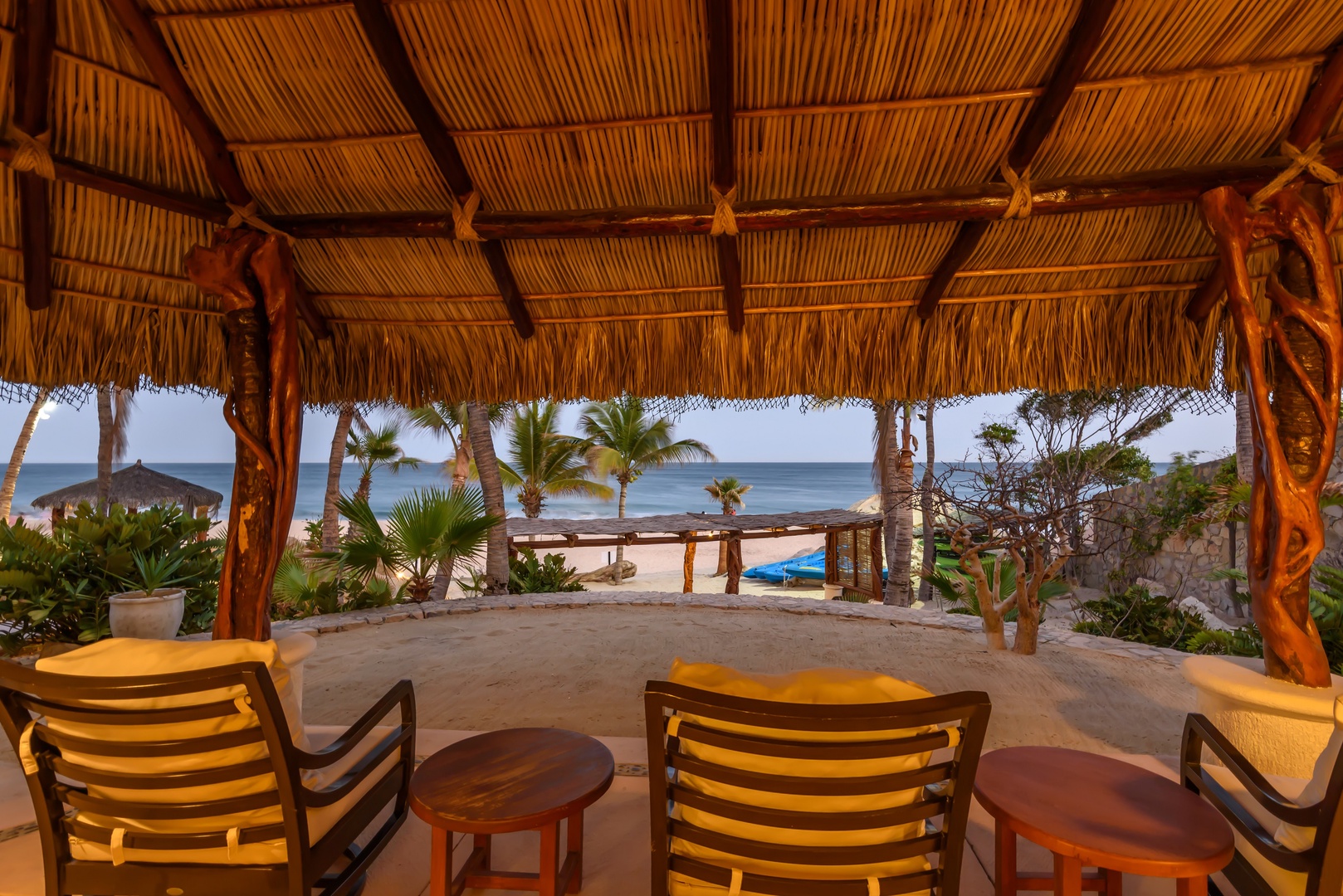 Sip your morning coffee beneath this thatched palapa as you gaze out at the serene ocean and swaying palms just steps away—your own slice of beachfront paradise.