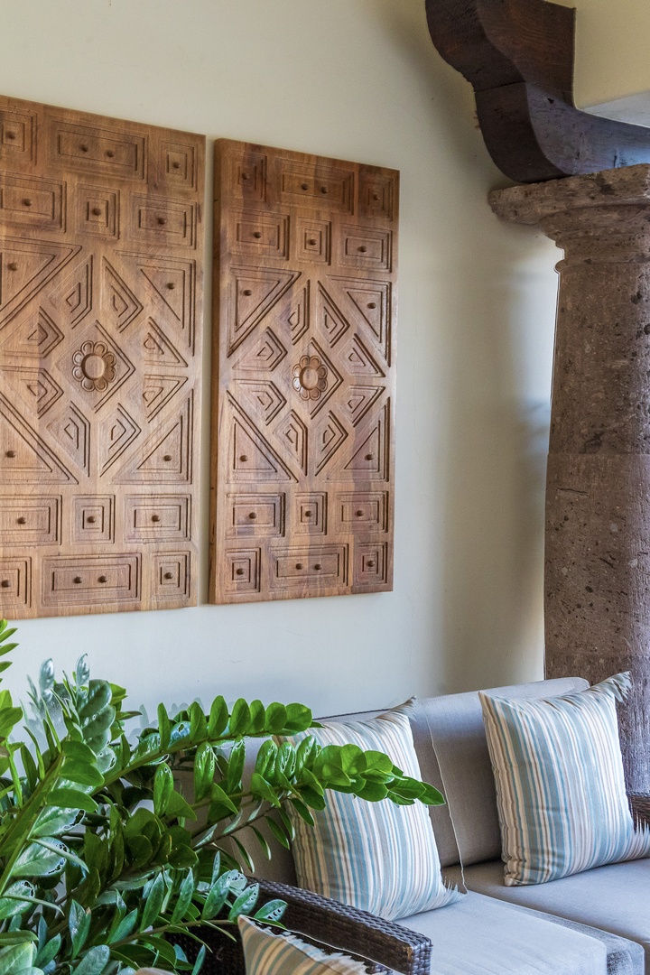 Sink into comfort in your stylish seating area, where handcrafted artisan panels and rustic beams create a warm, inviting ambiance for relaxation.