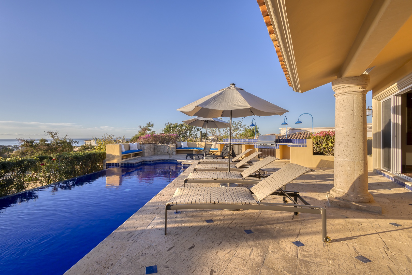 Stunning infinity pool terrace with ocean views and luxury loungers for ultimate relaxation.