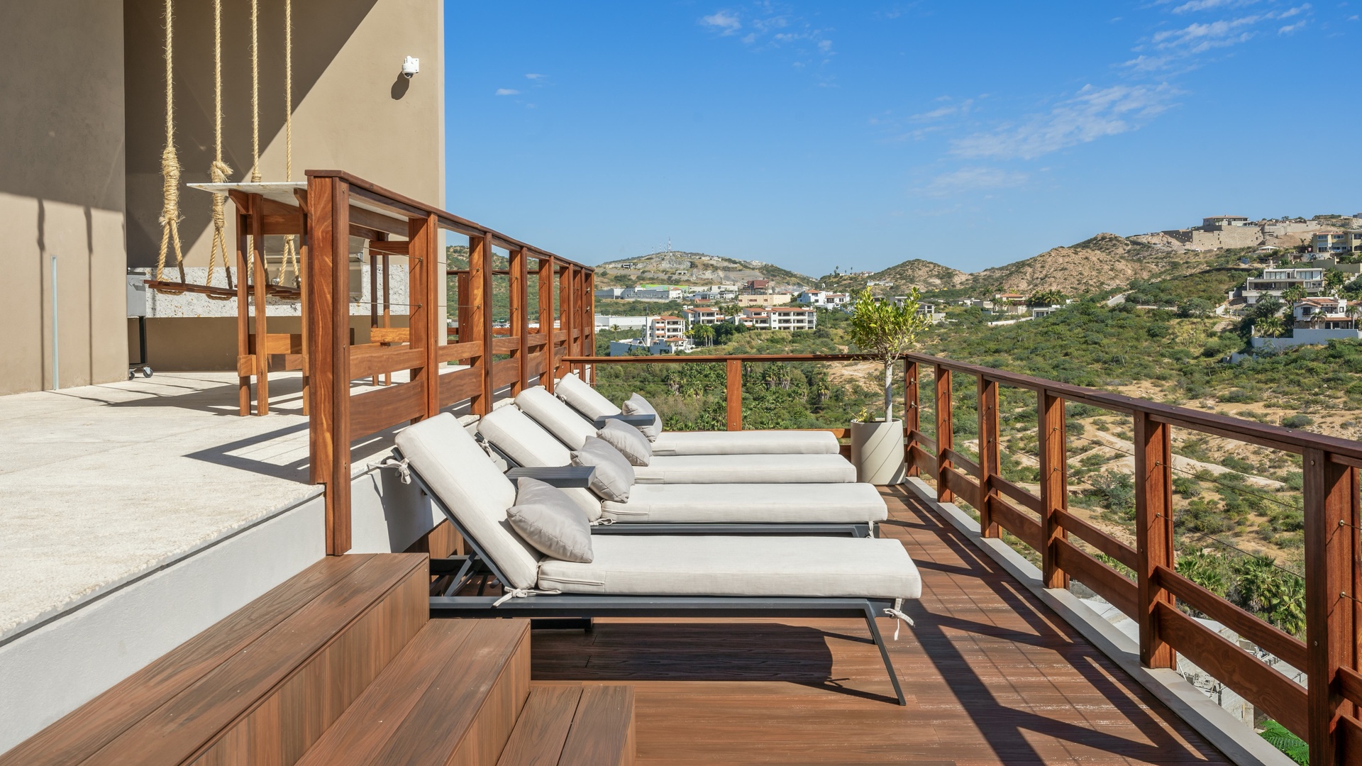 Stretch out on your private terrace and soak in stunning hillside views. The lounge chairs and wooden deck invite long, lazy afternoons under the sun.
