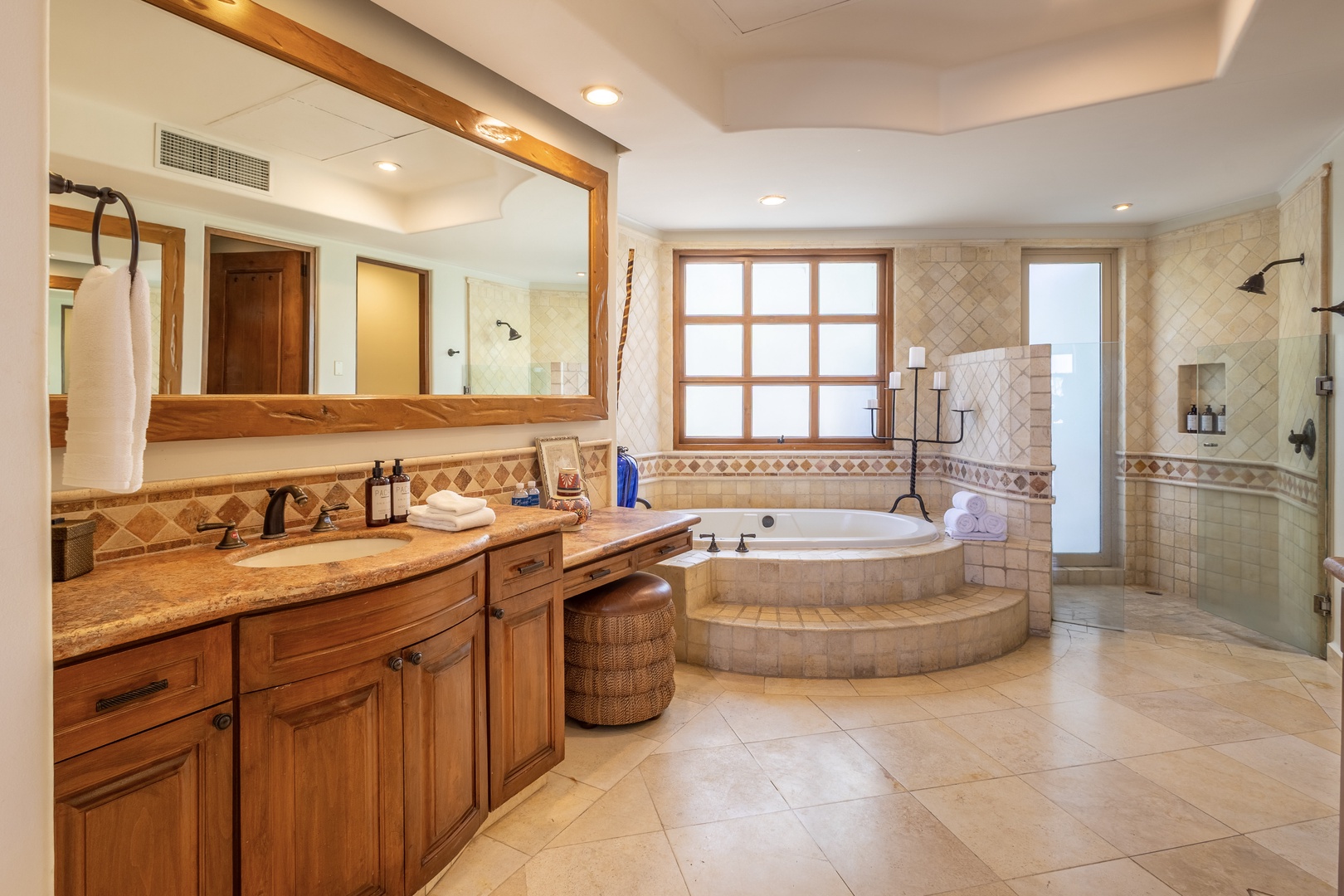 Unwind in your luxurious spa-like bathroom featuring a soaking tub, spacious shower, and elegant stone finishes for ultimate relaxation.