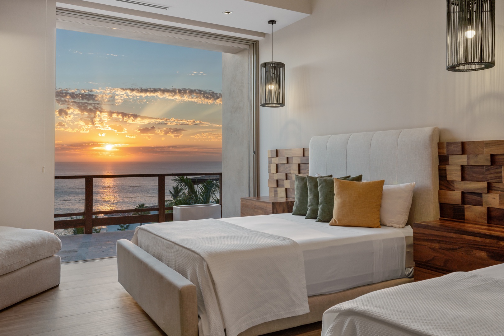 Wake up to breathtaking ocean sunrises framing your serene bedroom retreat. Elegant design, plush bedding, and pendant lighting create a peaceful sanctuary with stunning sea views.
