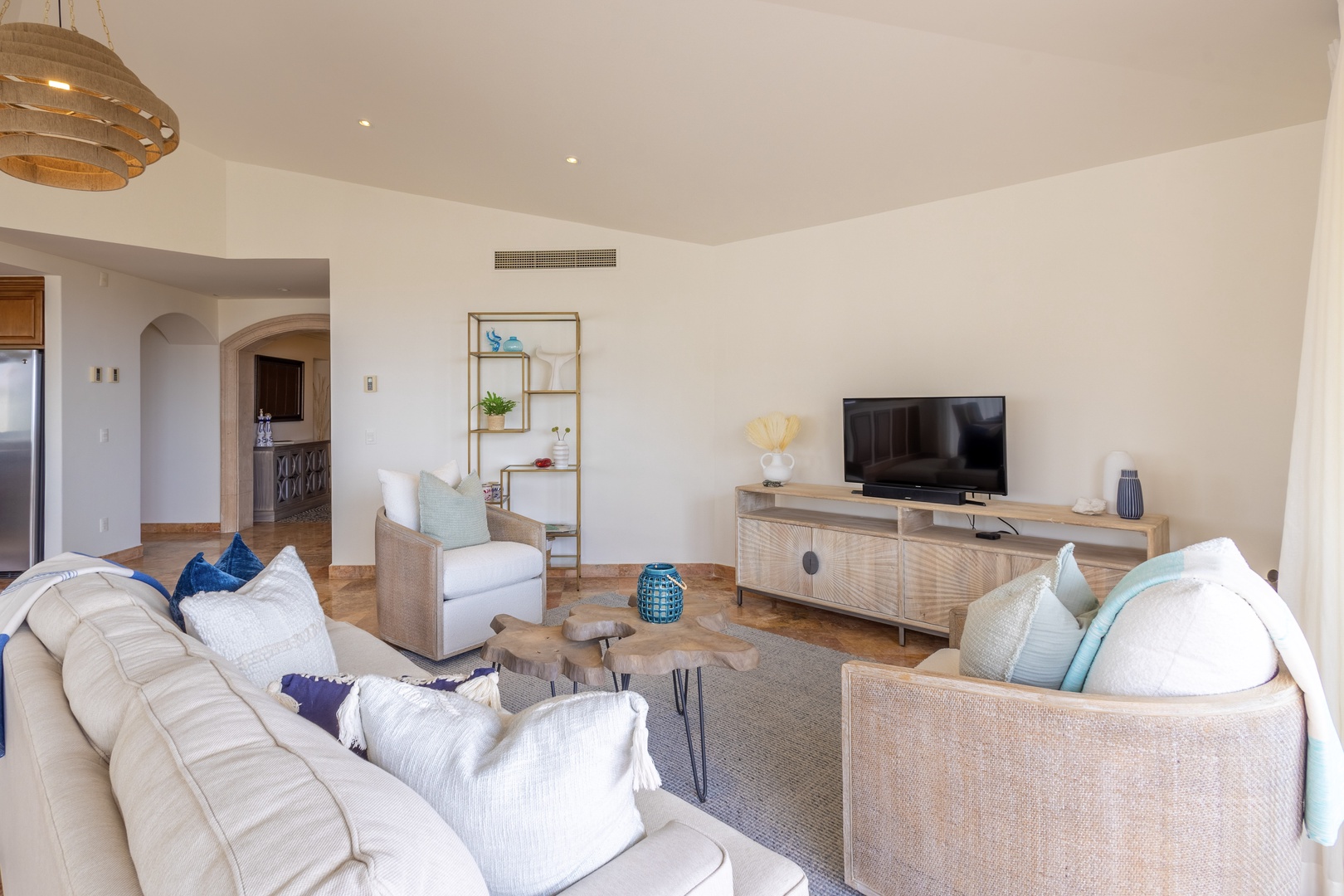 Sink into plush sofas in your elegant living space, where coastal blues meet warm neutrals for the perfect retreat.