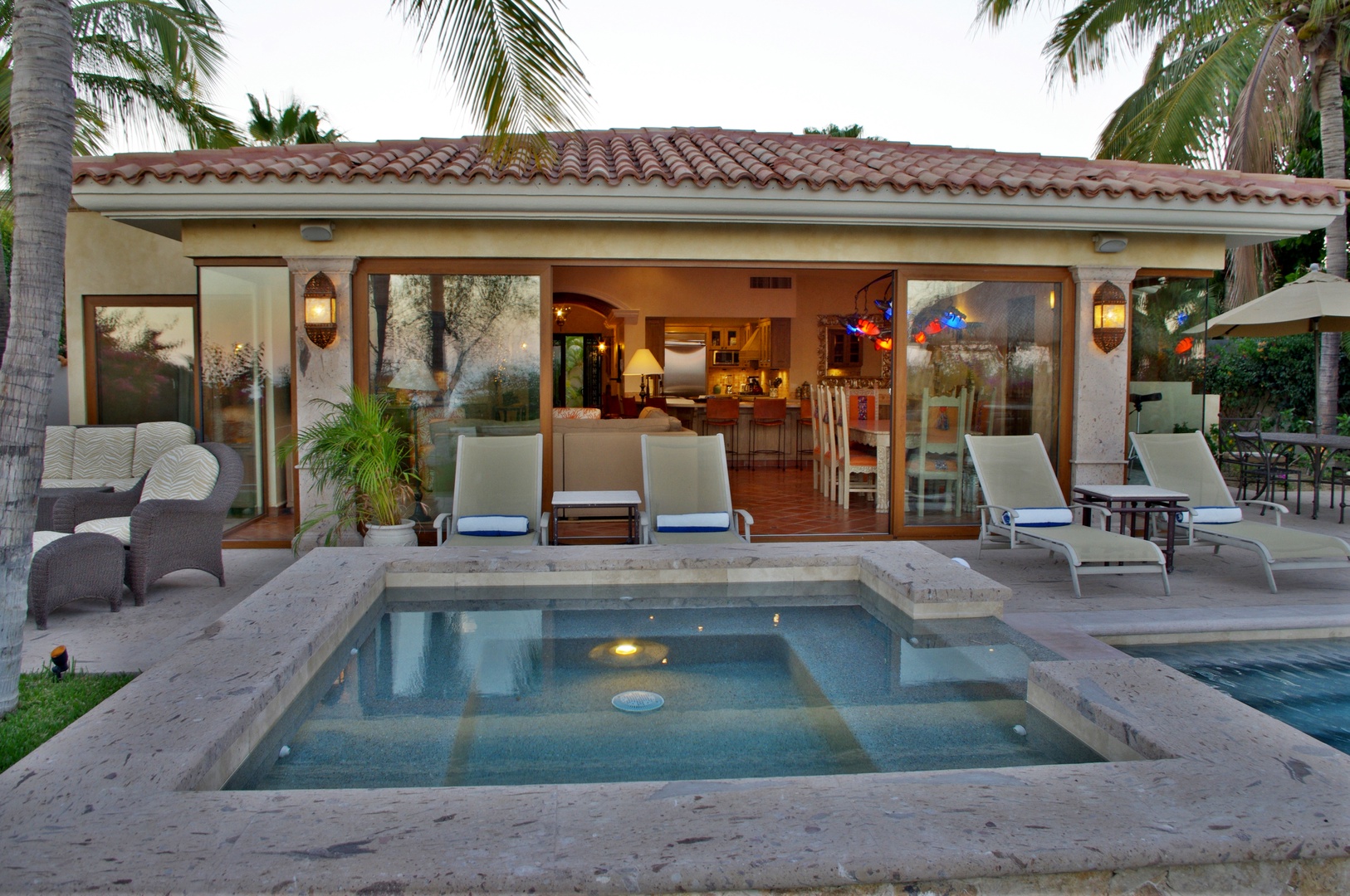 Picture yourself lounging poolside in your private tropical oasis, where the warm glow invites you to unwind and soak in the tranquil ambiance of paradise.