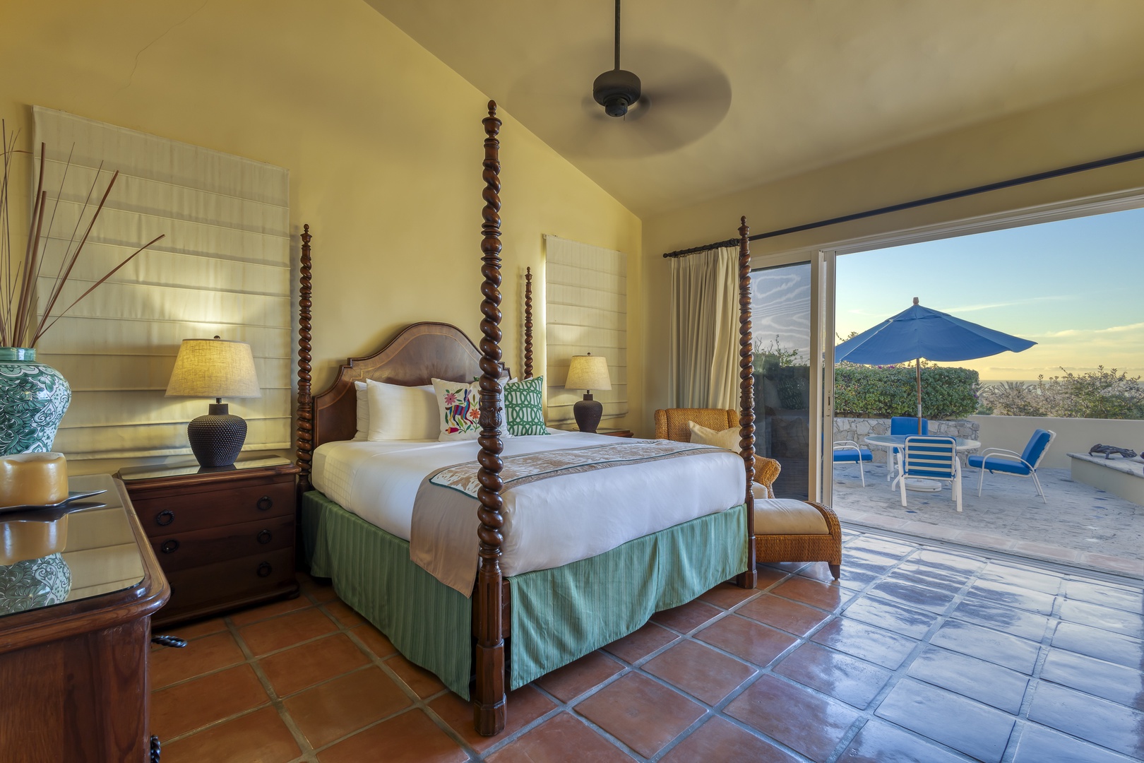 Your elegant four-poster bed awaits with crisp linens and tropical touches, while your private terrace beckons for morning coffee or sunset relaxation.
