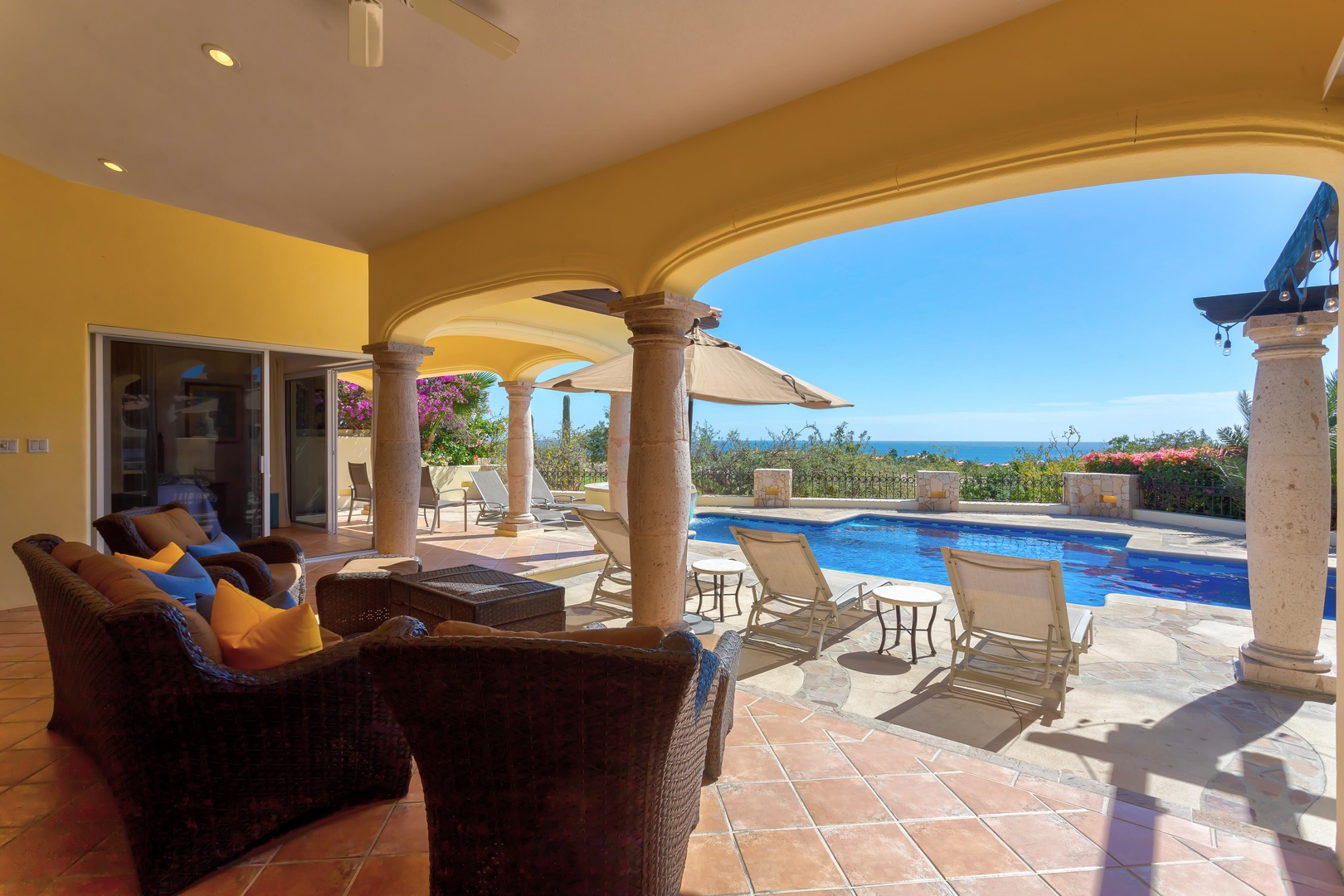 Relax in your private covered terrace with stunning ocean views, complete with pool and comfortable seating for ultimate vacation bliss.