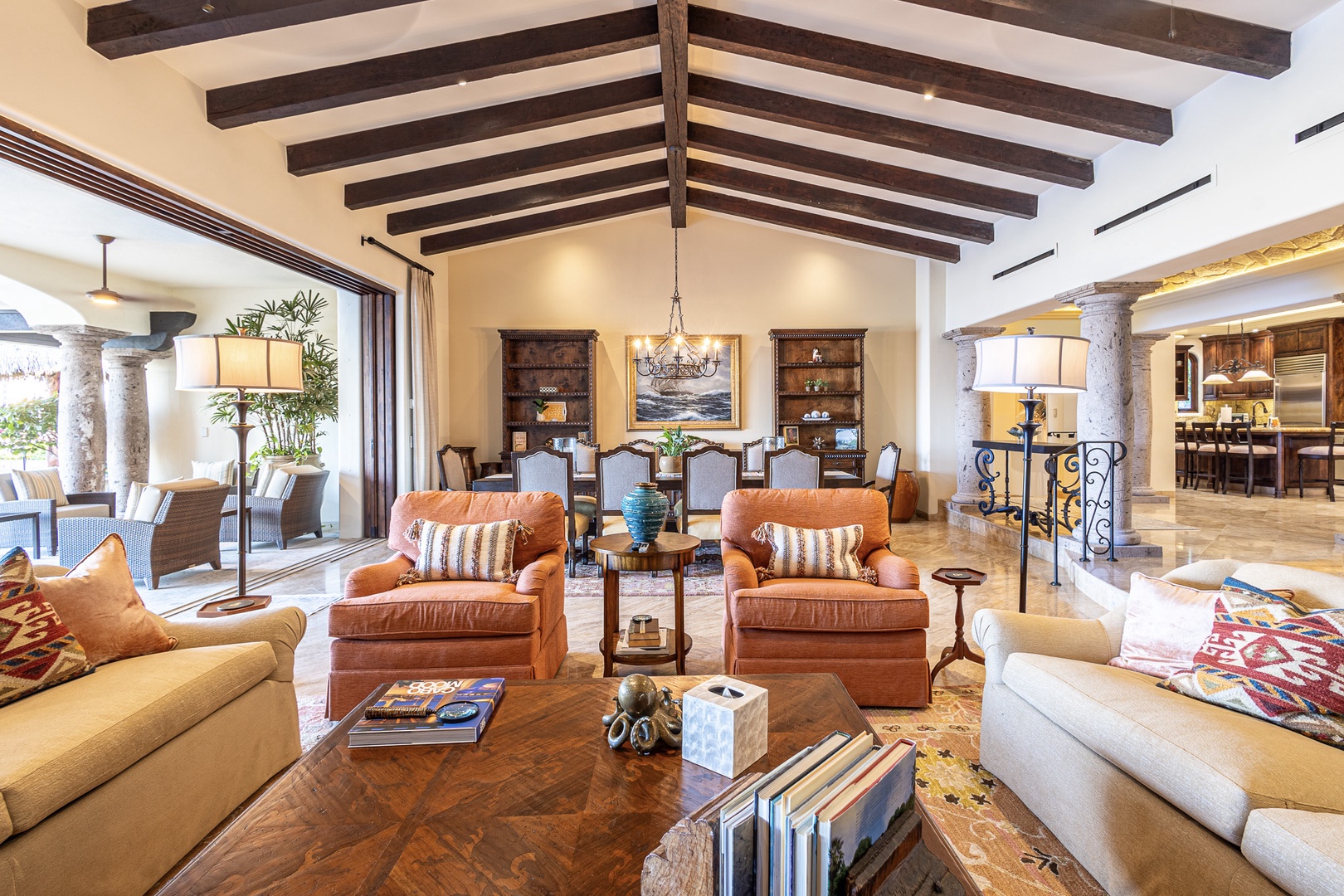 Picture yourself unwinding in this stunning open-concept living space, where soaring beamed ceilings and warm natural light create an inviting atmosphere for your perfect getaway.