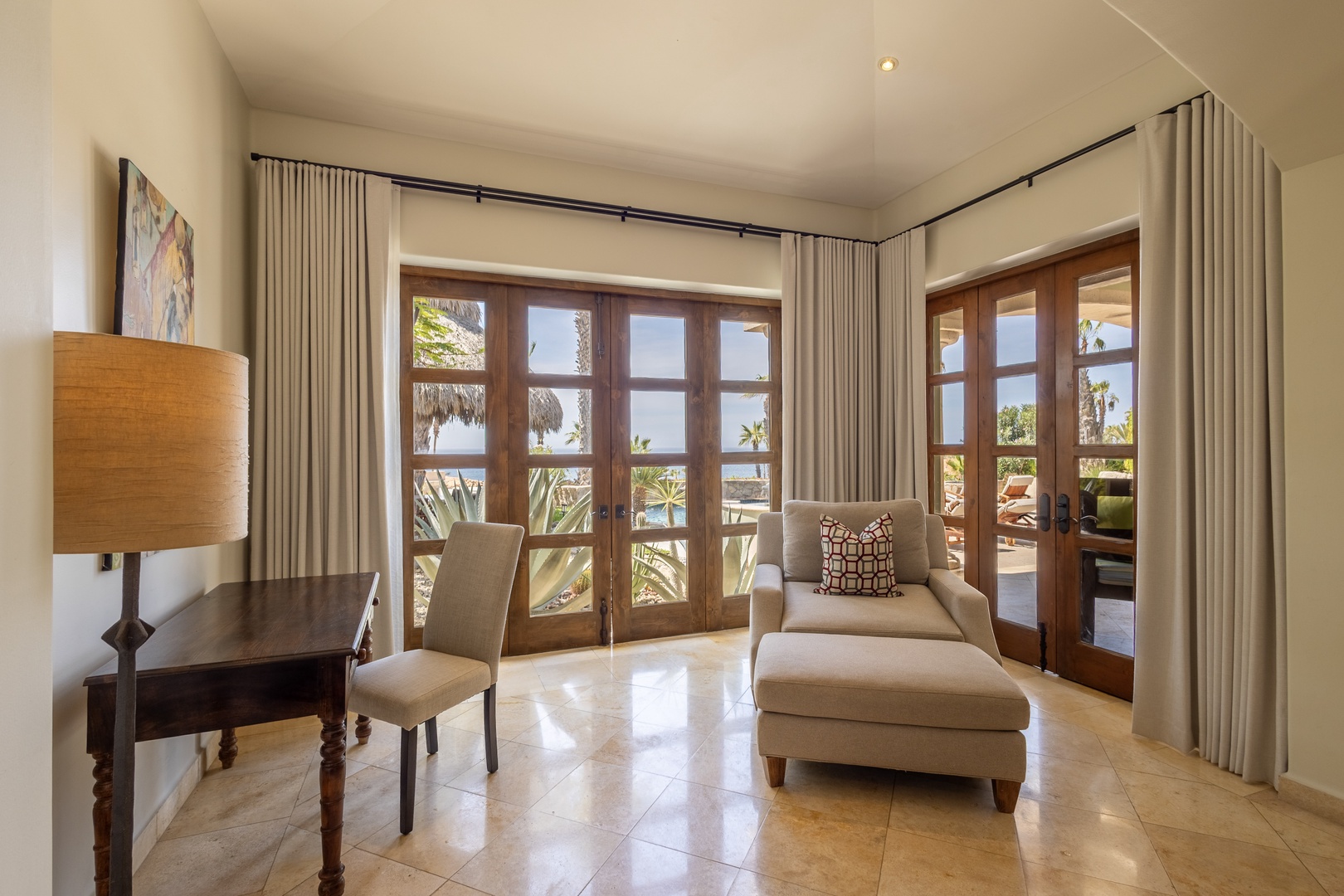 Your private sanctuary features warm wood accents and tropical views through French doors that open to your own terrace.