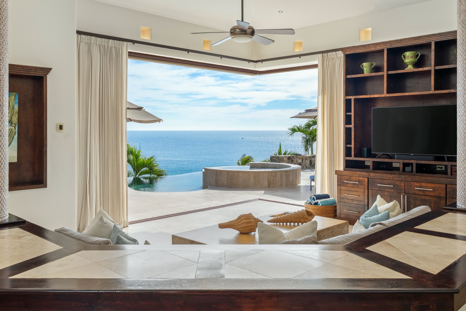 Your spacious living room opens to breathtaking ocean views, with a private hot tub awaiting your relaxation moments.