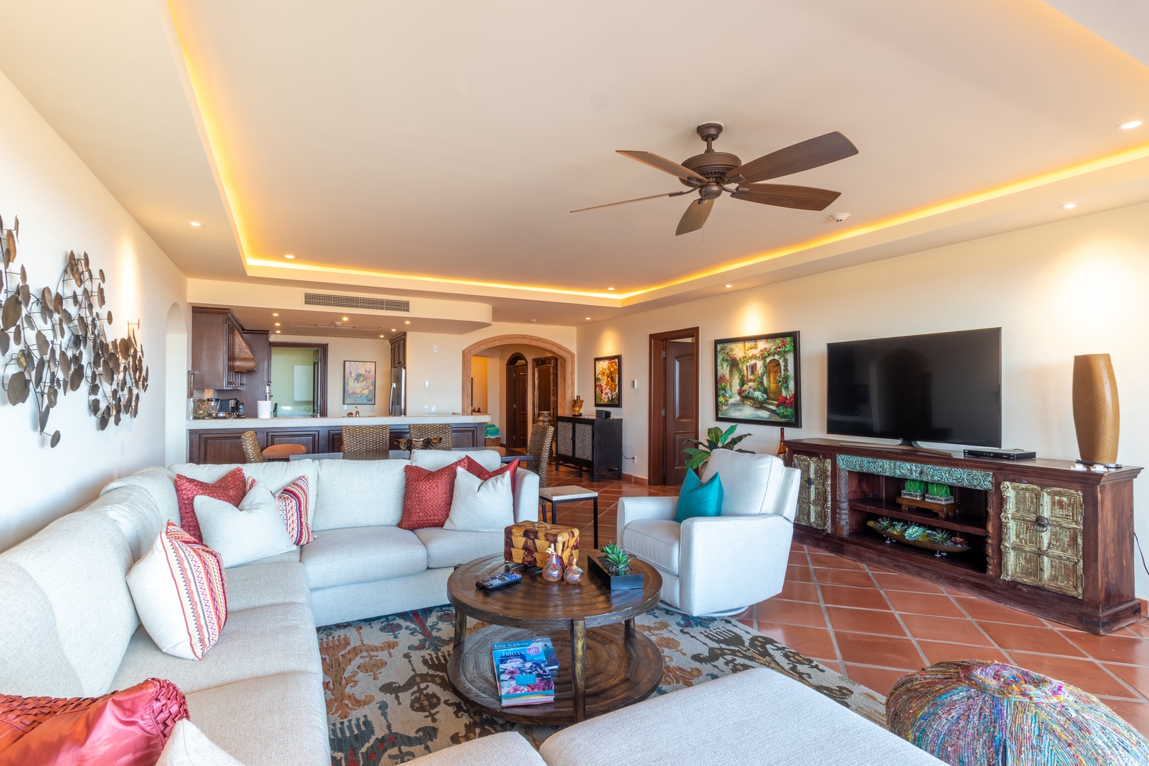 Sink into plush sofas in your elegant living room, where warm lighting and thoughtful decor create a welcoming retreat after your day of adventure.