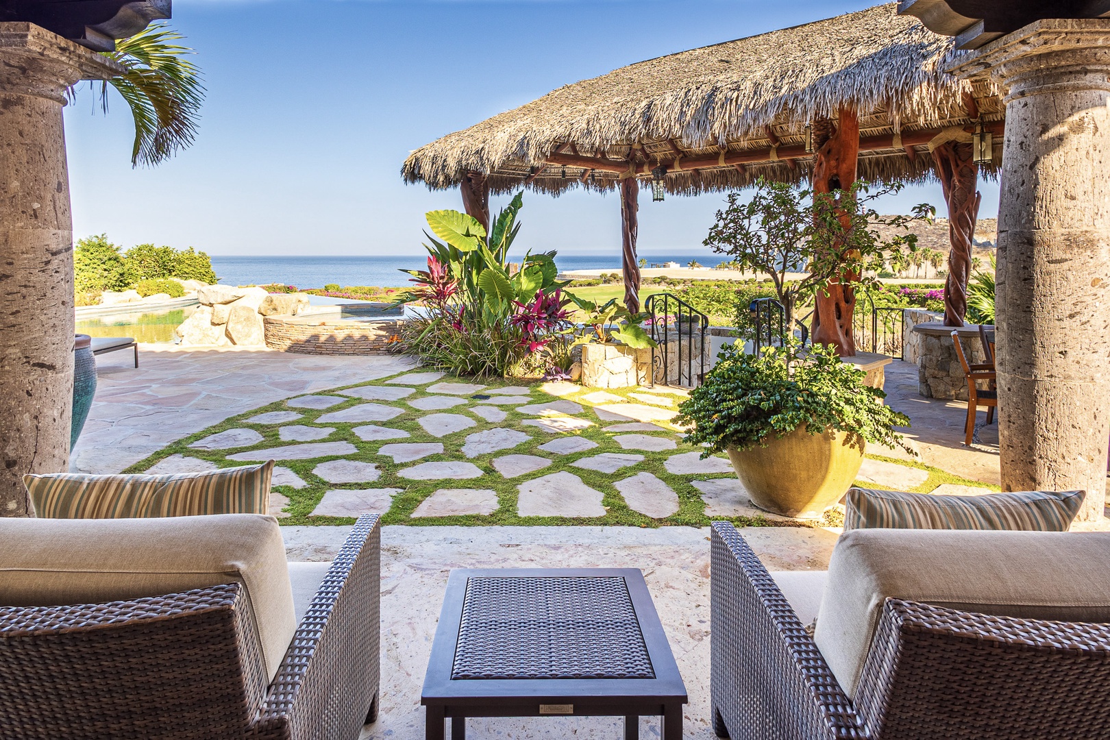 Sink into plush seating and gaze at sparkling ocean views from your private terrace, where tropical breezes and lush gardens create your perfect escape.