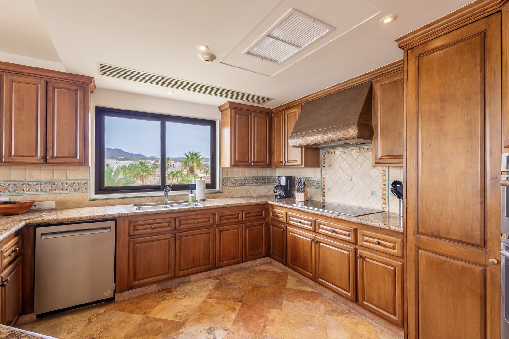 Your gourmet kitchen features granite counters, premium appliances, and scenic mountain views while you prepare meals.